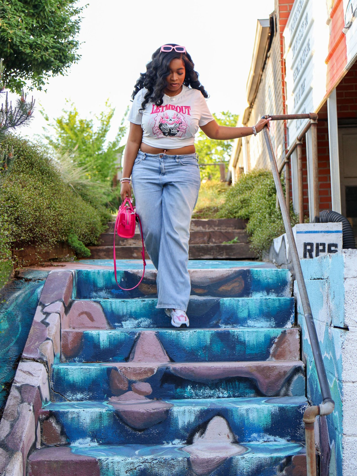 Artistic painted steps in shades of blue and purple create a vibrant outdoor staircase display.