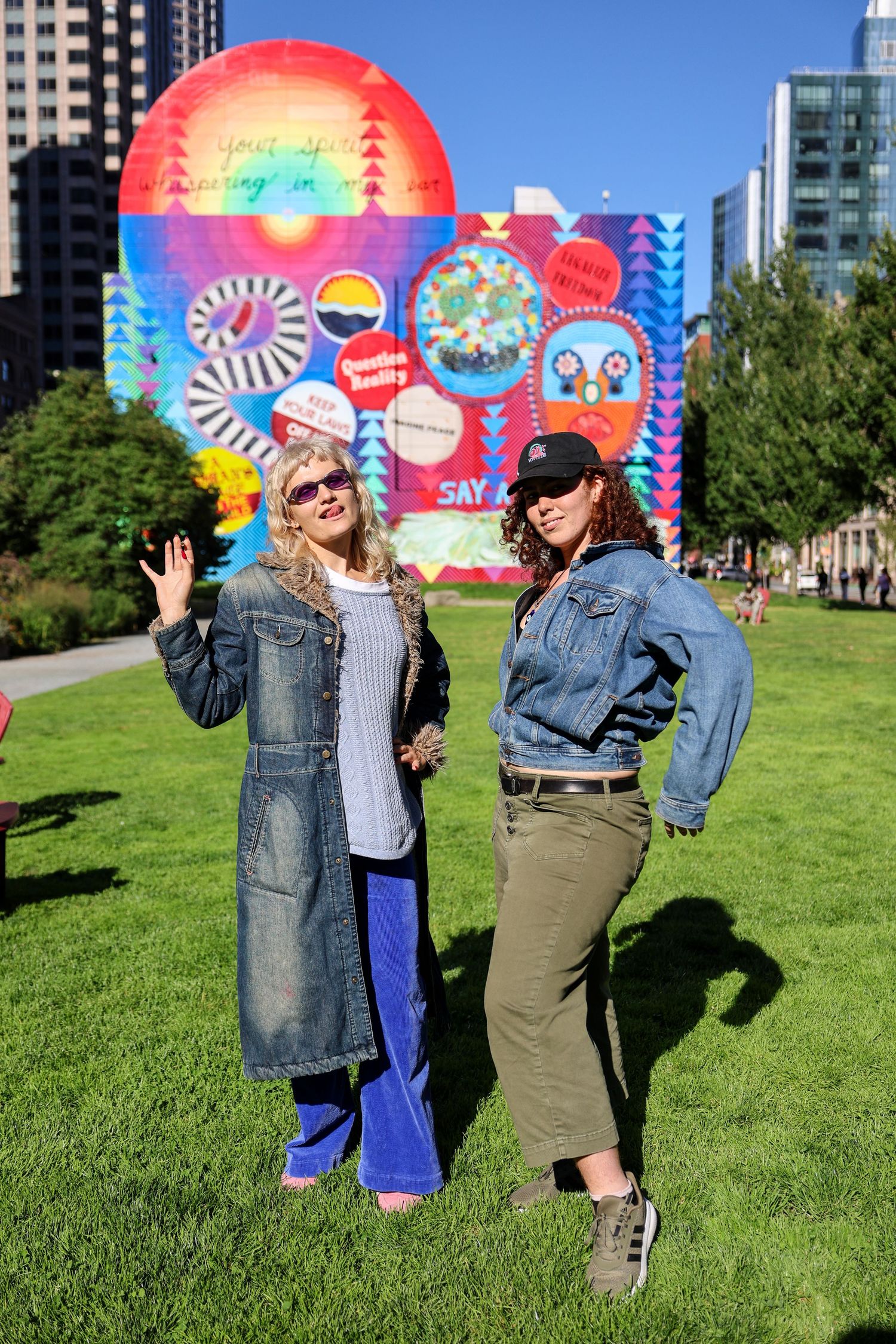 Candid moments captured against colorful mural backdrop in urban park setting.