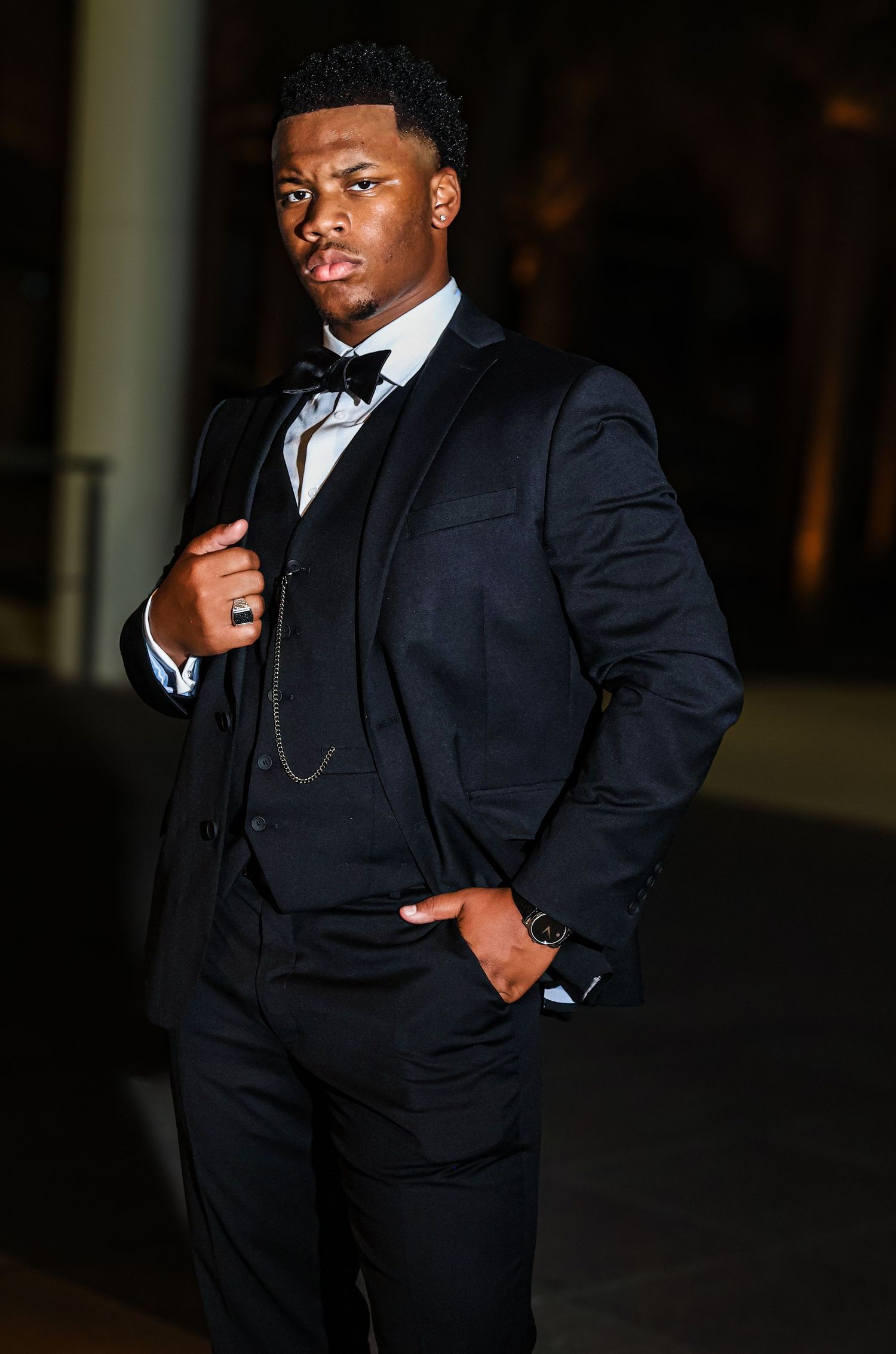 Stylish formal portraits showing different poses in a classic black suit and tie.