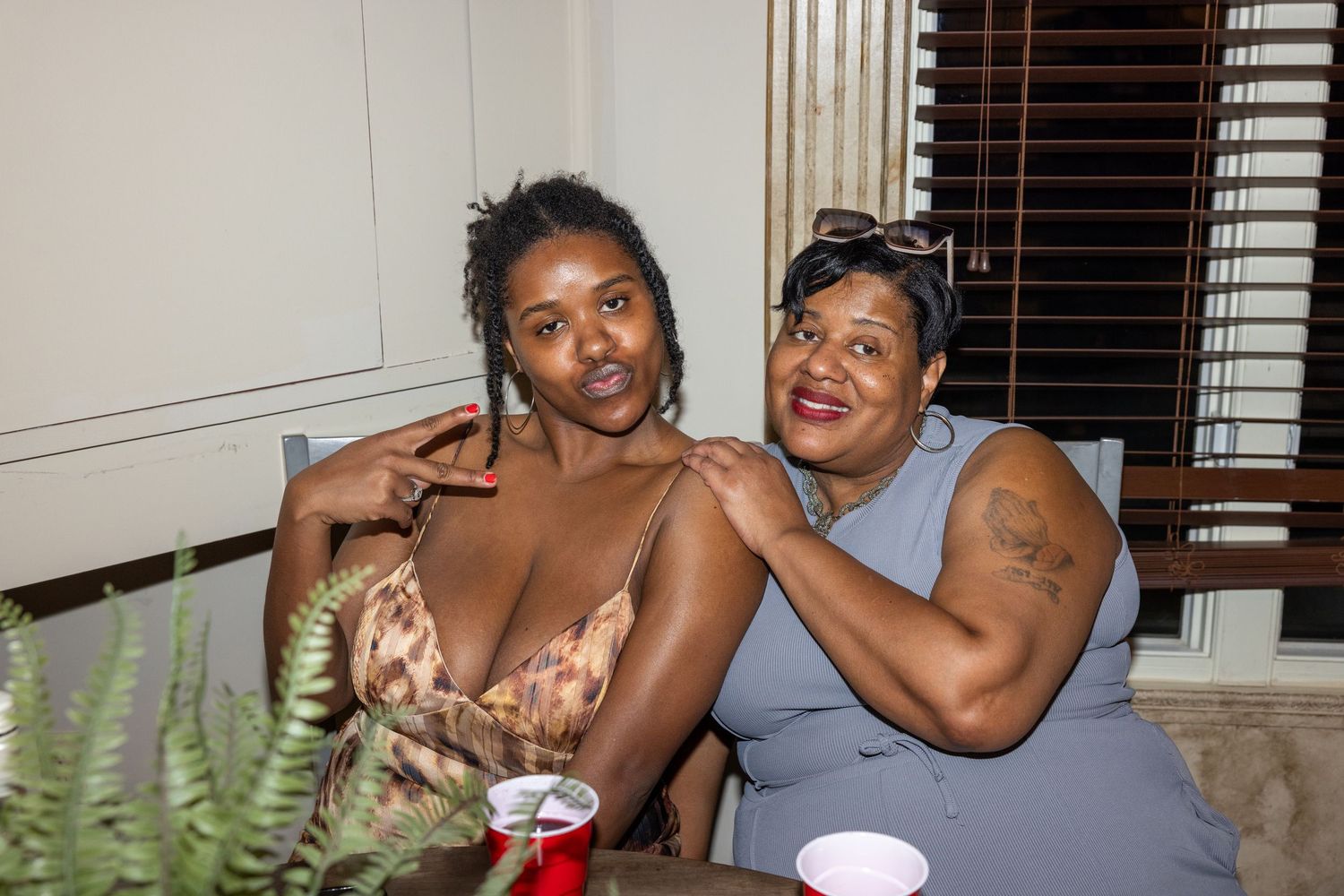A group of friends enjoying a casual gathering indoors with laughter and smiles.