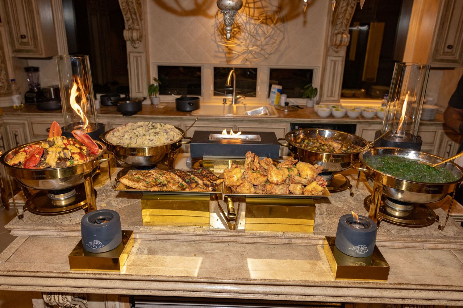 Elegant buffet spread with various dishes and appetizers displayed on a long table in an ornate dining room.
