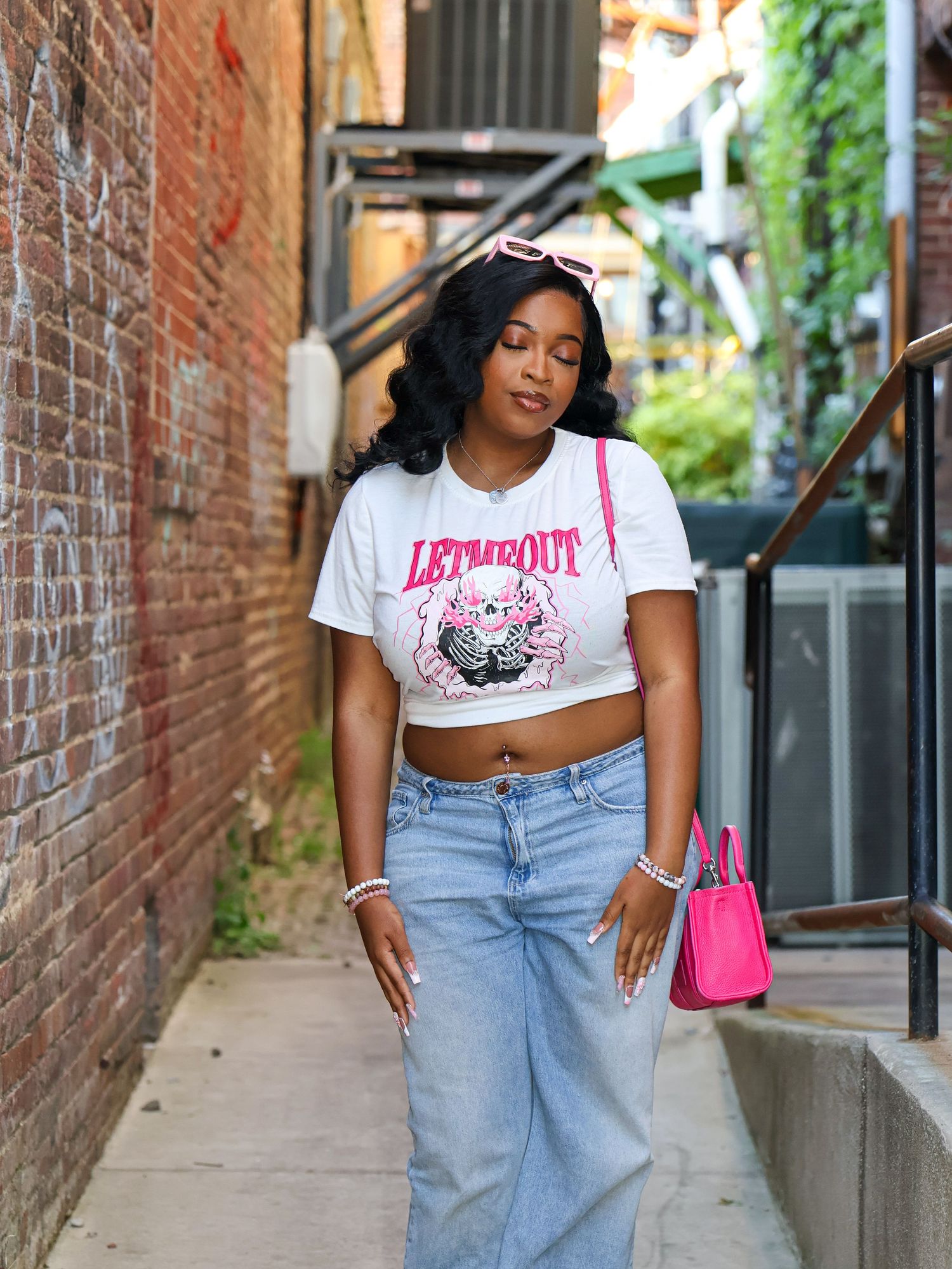 Fashion photography against rustic brick wall backdrop in urban setting.