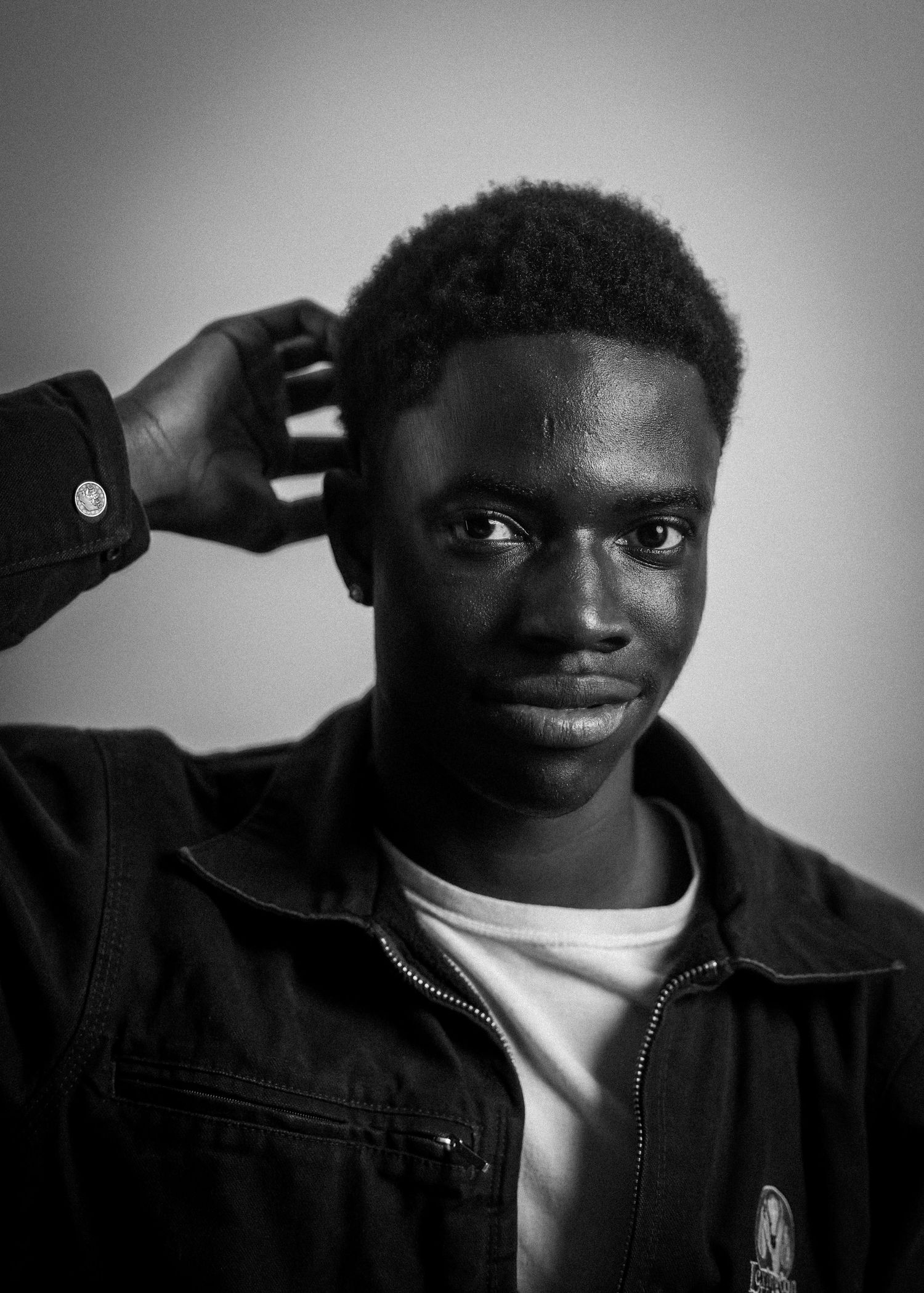 Black and white portrait series showing playful gestures and expressions.
