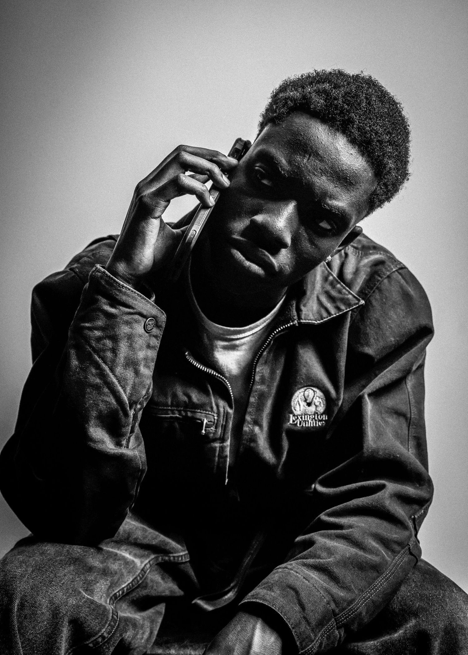 Black and white portraits showing relaxed poses in casual jacket.