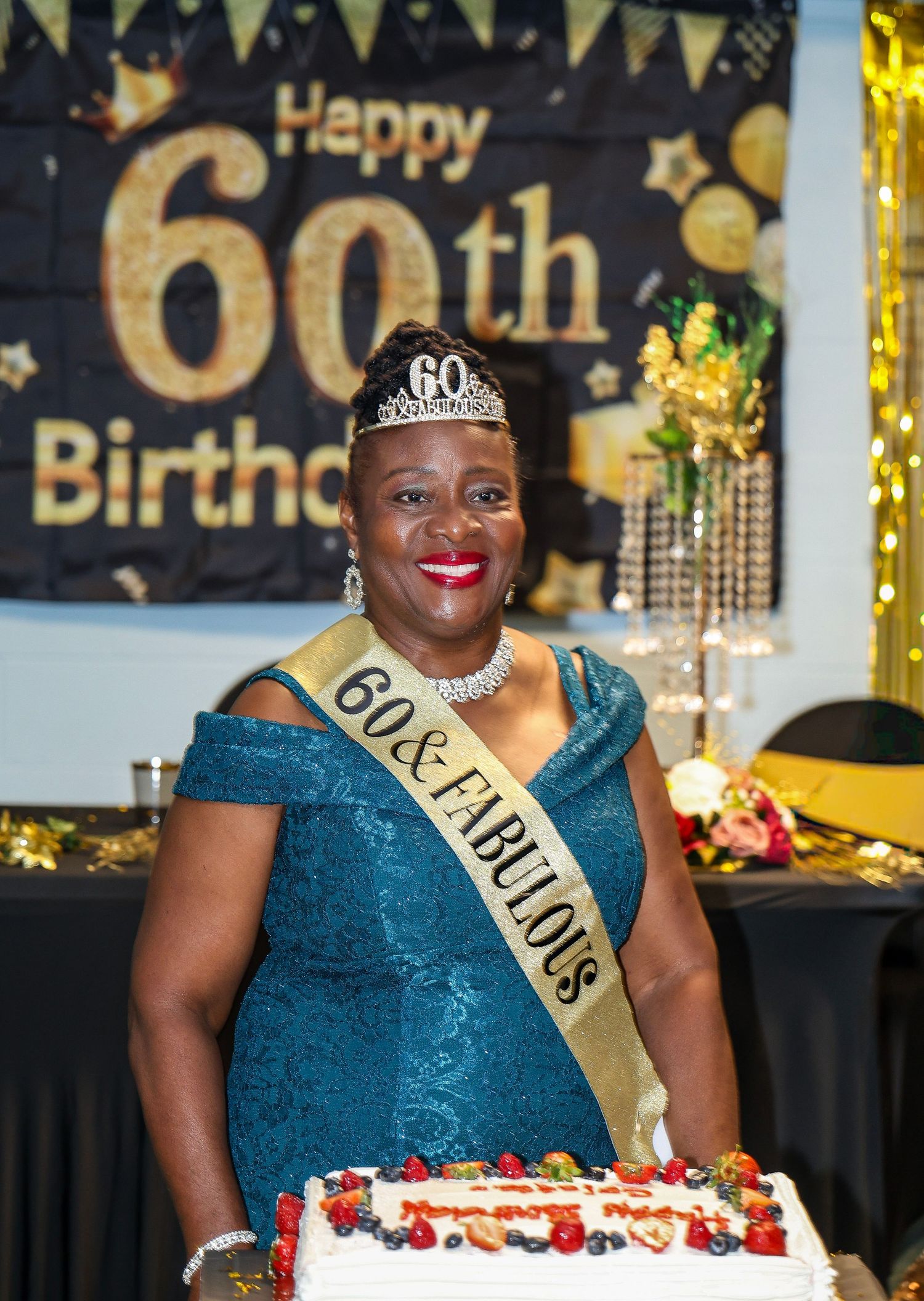 A 60th birthday celebration with decorative gold lettering and party decorations.