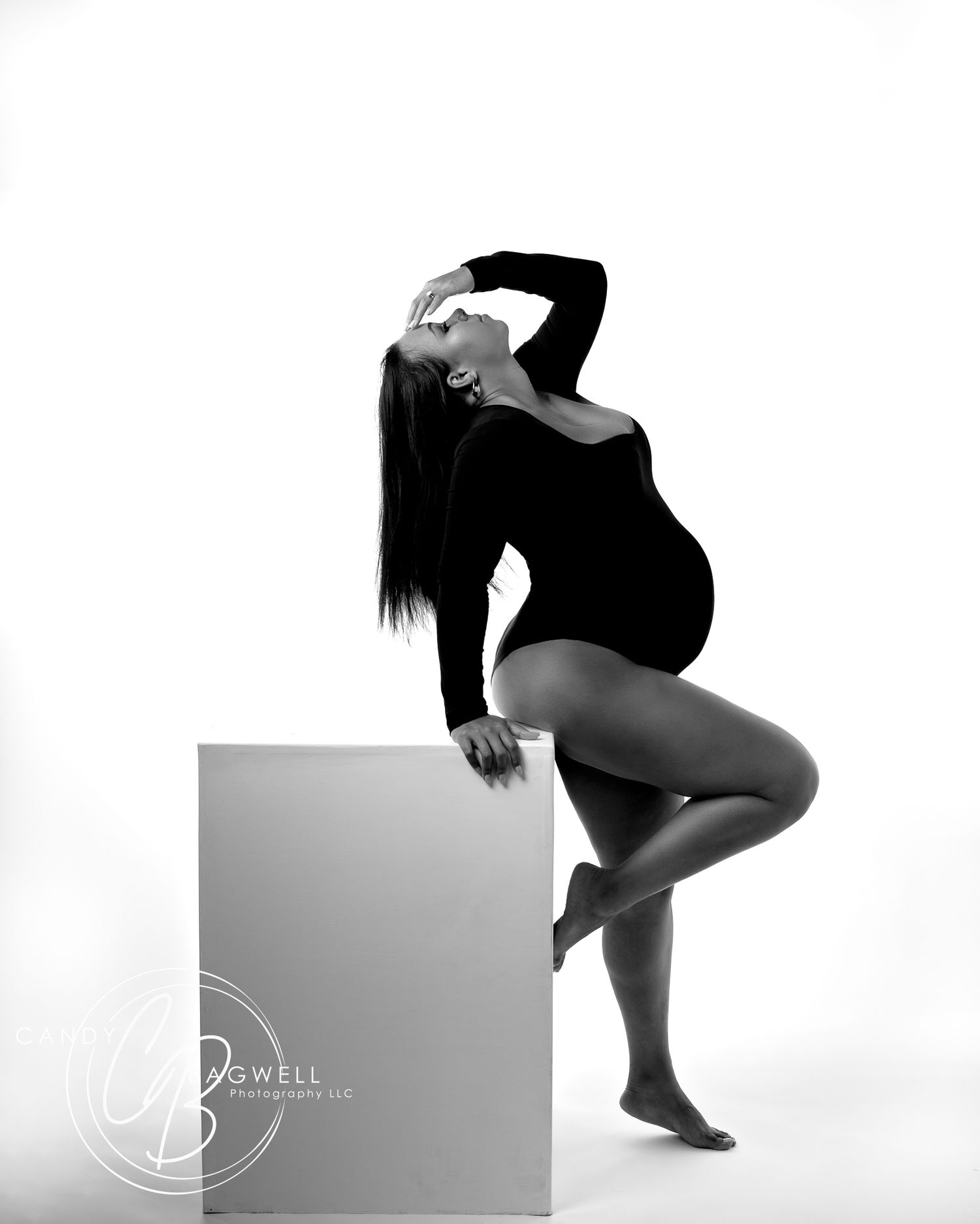 Black and white studio maternity portrait with dramatic posing and modern styling by Candy Bagwell Photography in Fletcher, NC.