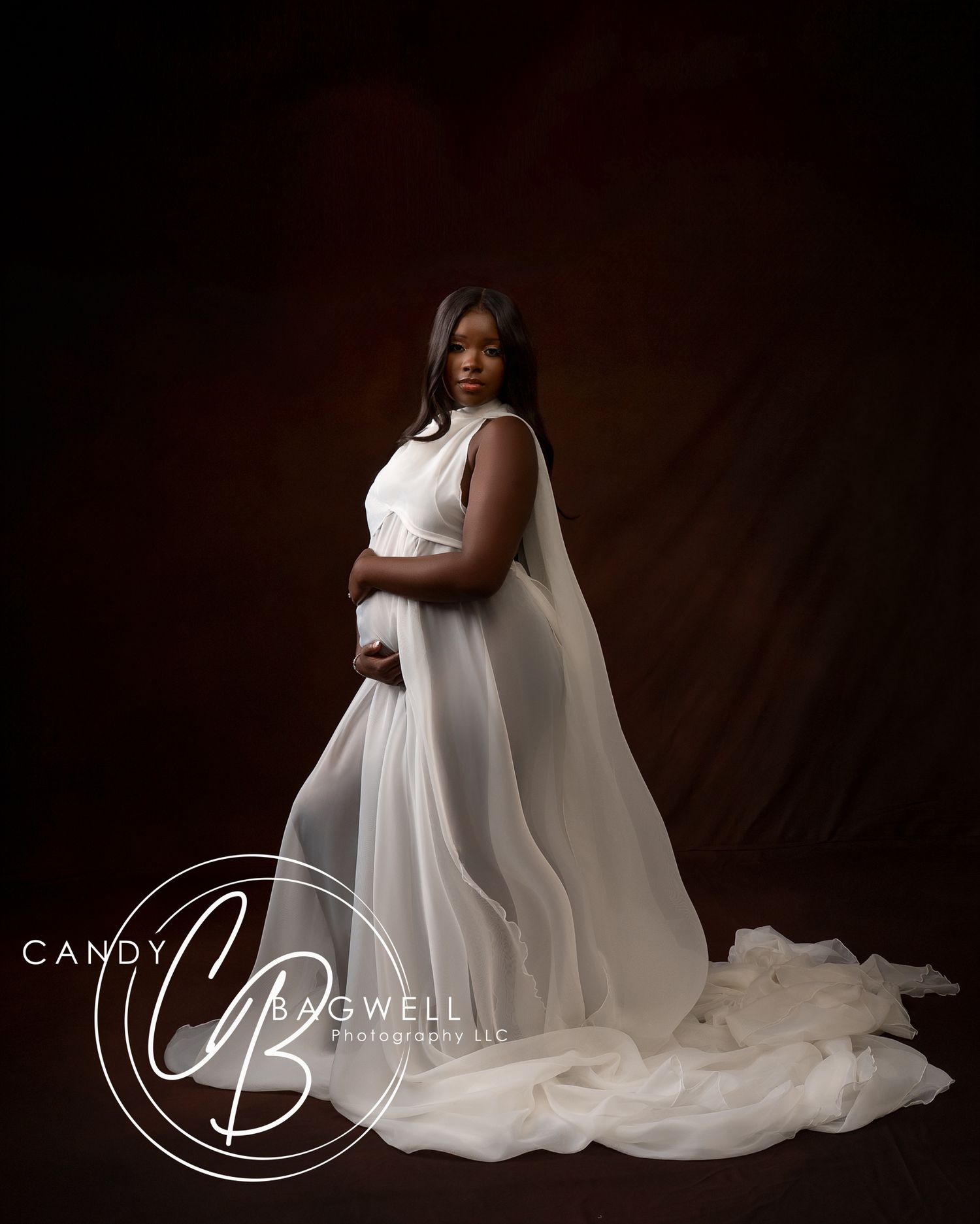 Fine art maternity portrait featuring an expecting mother in a flowing white gown by Candy Bagwell Photography in Fletcher, NC.