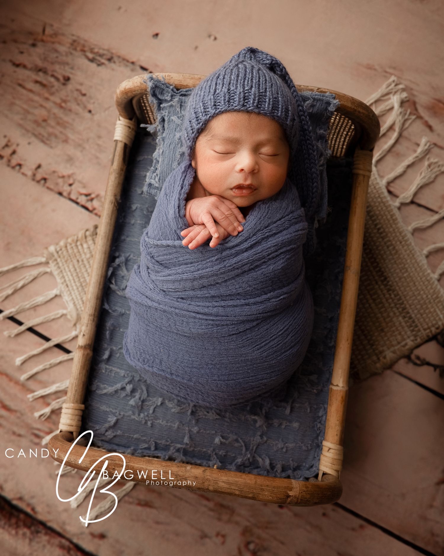 Cozy newborn portrait of a sleeping baby wrapped in blue by Candy Bagwell Photography, newborn photographer in Fletcher, NC.
