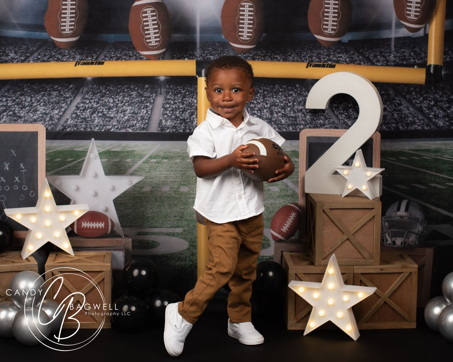 2nd birthday portrait with a fun football theme by Candy Bagwell Photography, serving Fletcher, Asheville, and Western NC.