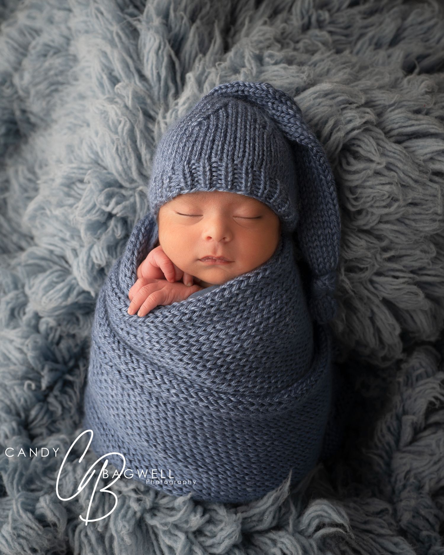 Cozy newborn portrait of a sleeping baby wrapped in blue by Candy Bagwell Photography, newborn photographer in Fletcher, NC.