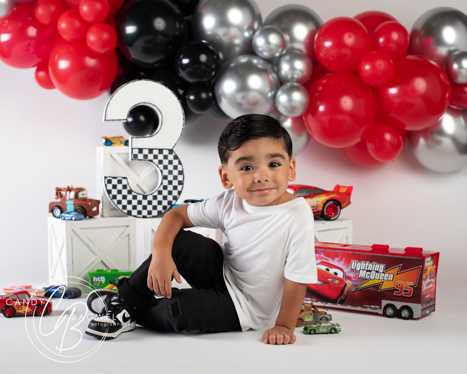 3rd birthday portrait with a fun race car theme and colorful balloons by Candy Bagwell Photography, serving Fletcher and Western NC.