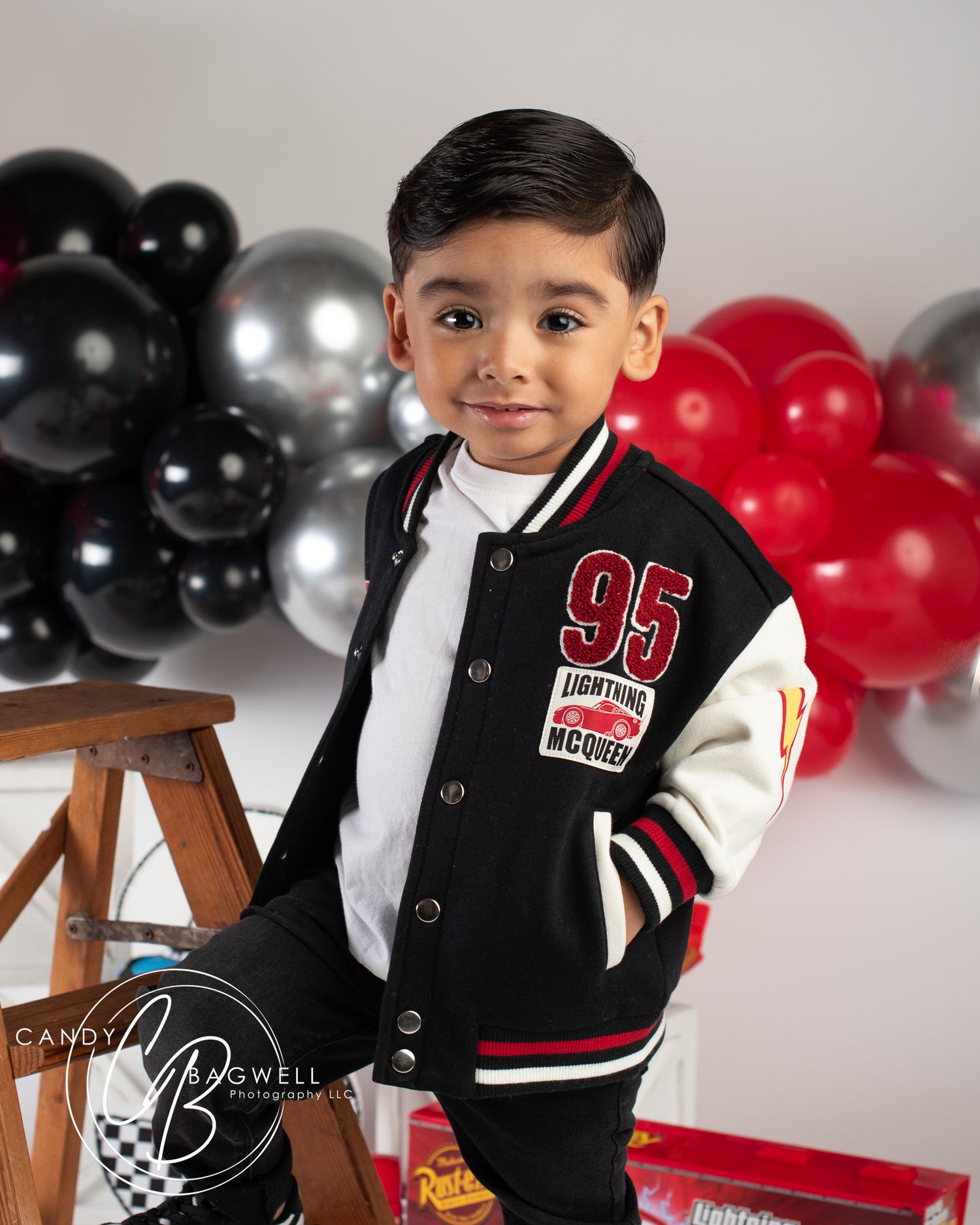 3rd birthday portrait with a fun race car theme and colorful balloons by Candy Bagwell Photography, serving Fletcher and Western NC.