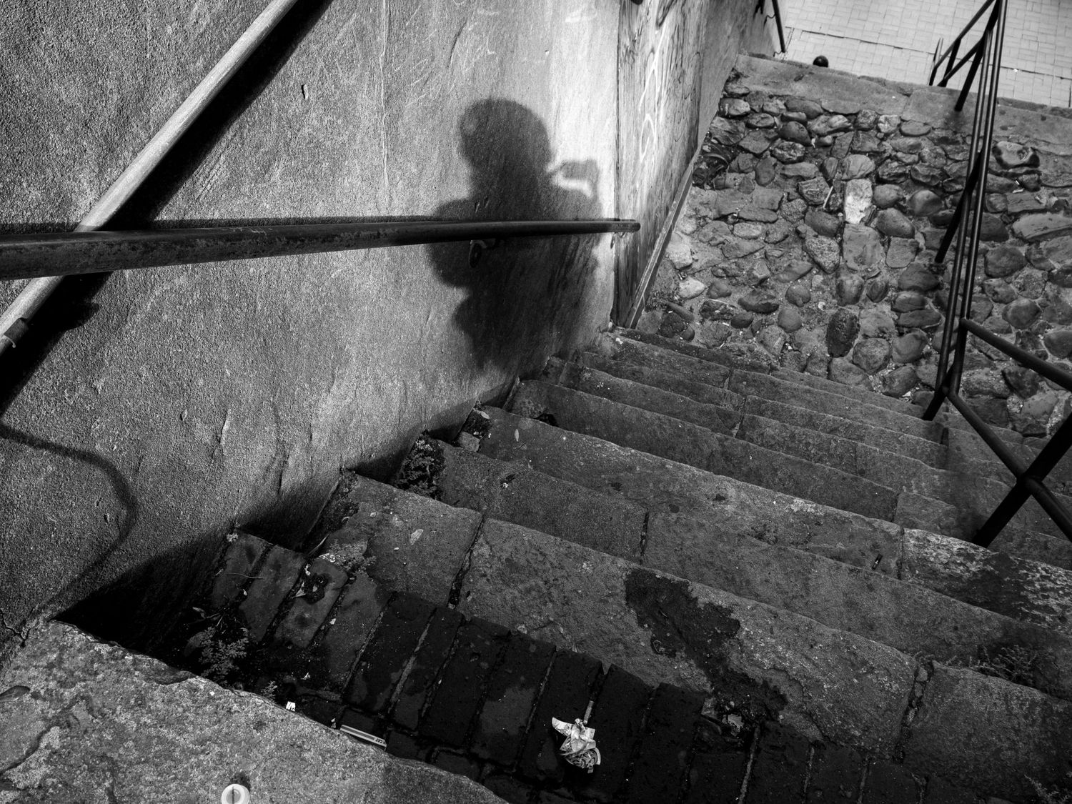 A series of black and white photographs showing deteriorating concrete steps and walkways in an urban setting.