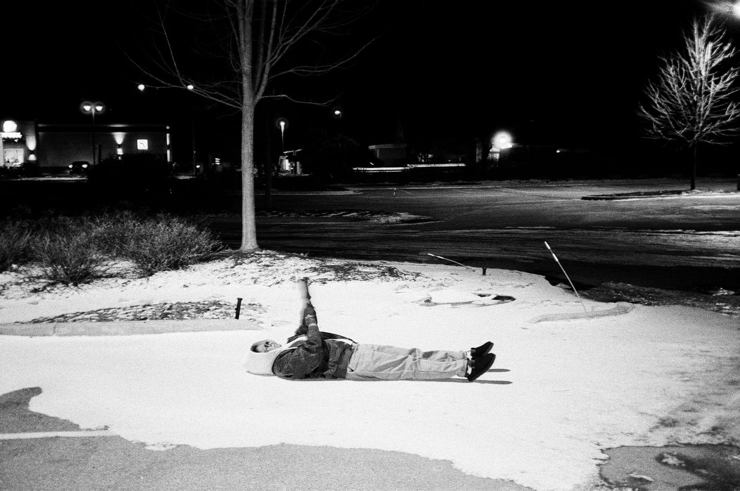 A black and white photo montage showing snowy winter landscapes with trees and paths at night.