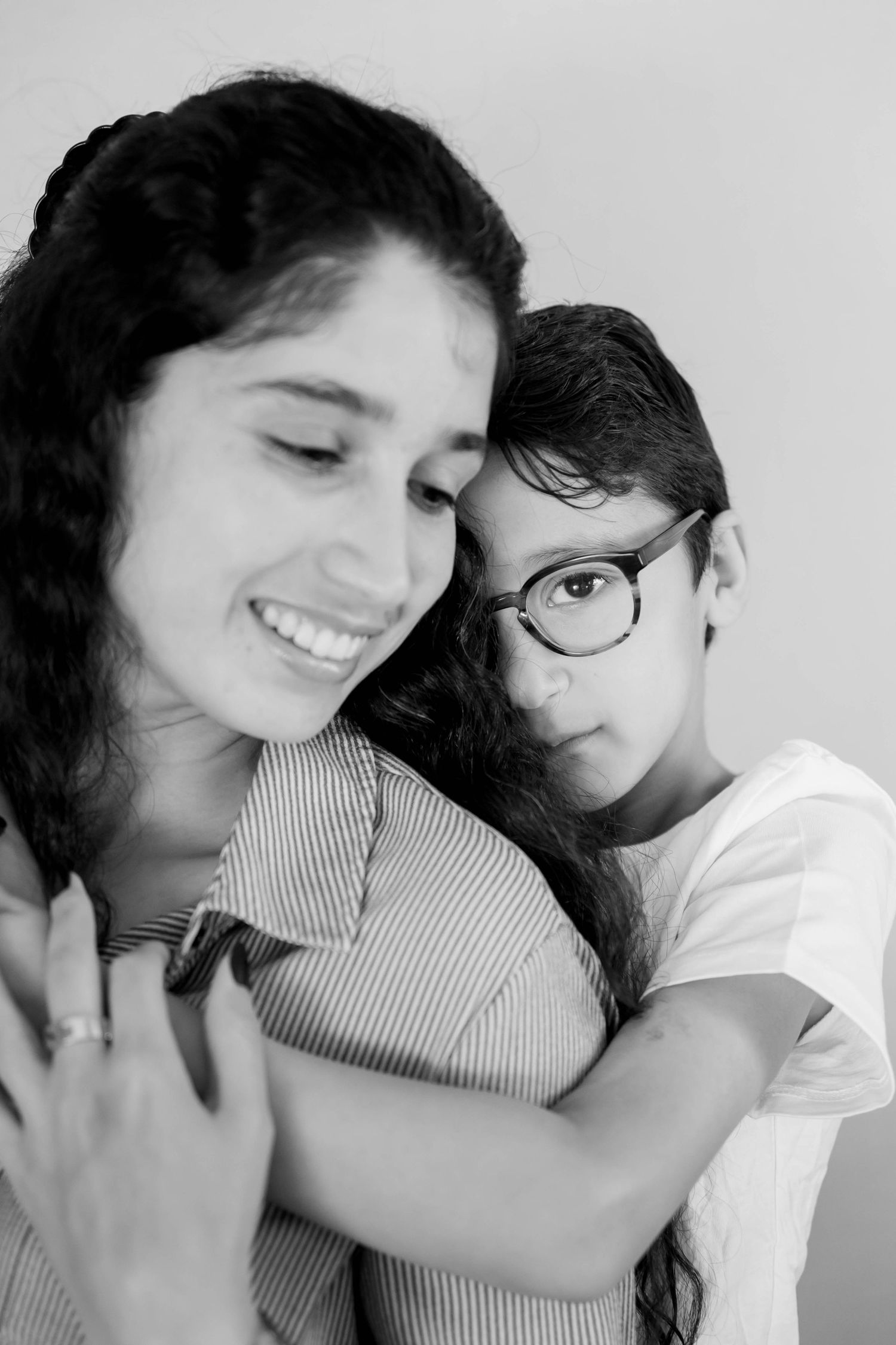 A romantic black and white photo series showing a couple embracing and sharing intimate moments together.