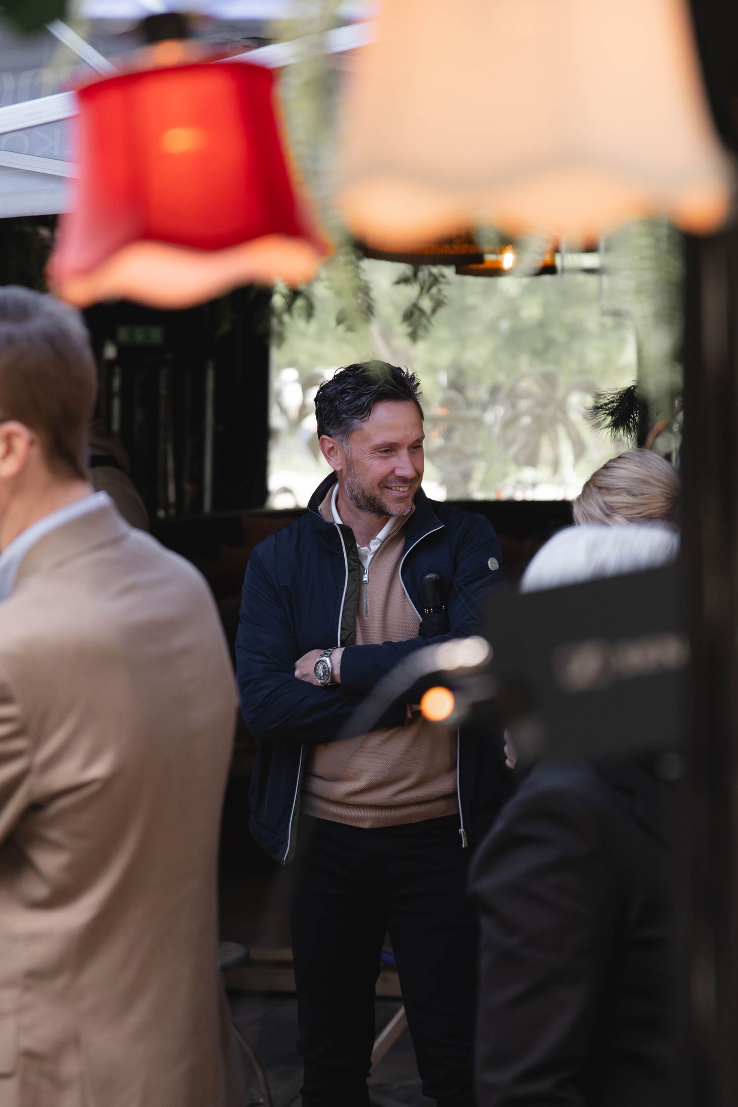 Several people in formal business attire are gathered at what appears to be a professional networking event.