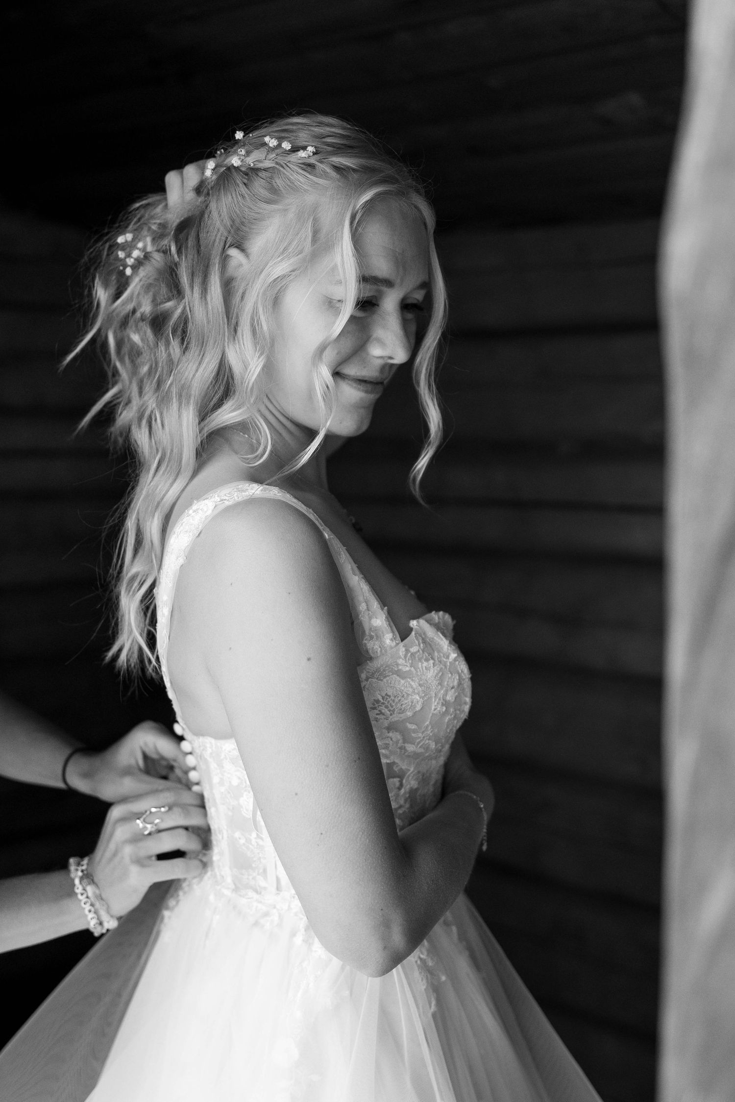 A black and white series of photos showing a bride laughing joyfully in her white lace wedding dress.