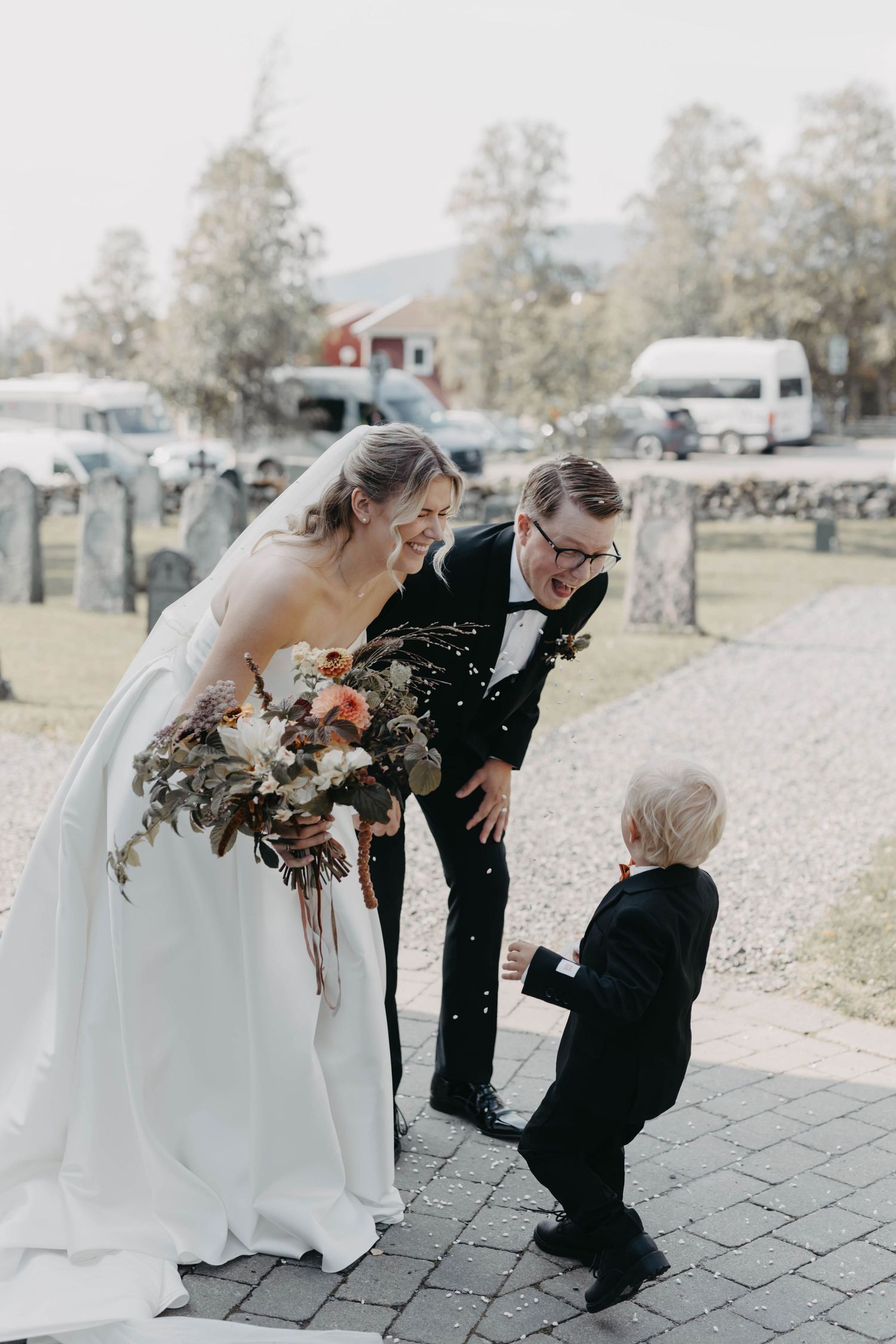 A heartwarming sequence of wedding photos showing a tender moment between a small child and a bride and groom outdoors.