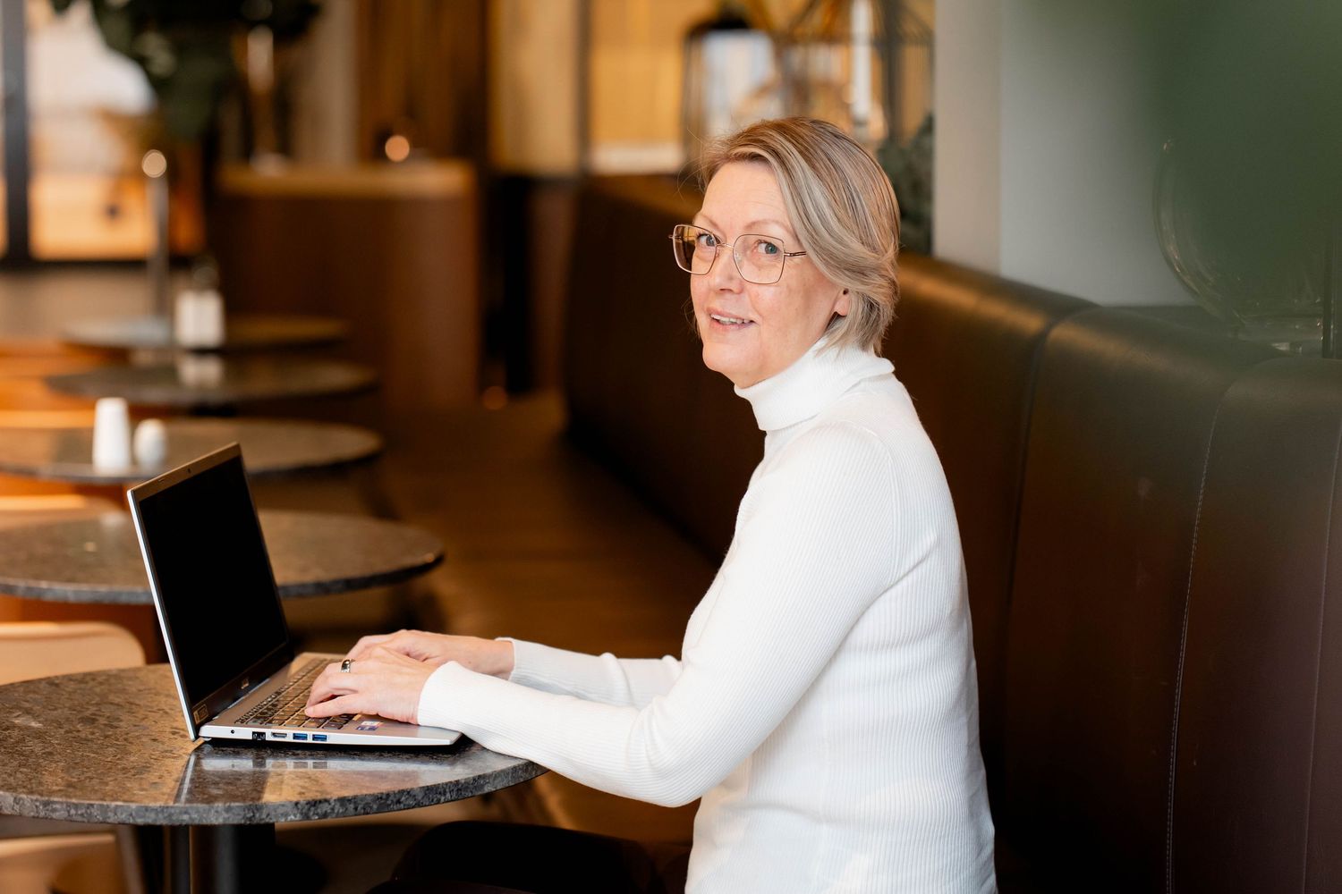 A series of candid shots showing someone in a white blazer seated at different tables in a restaurant setting.
