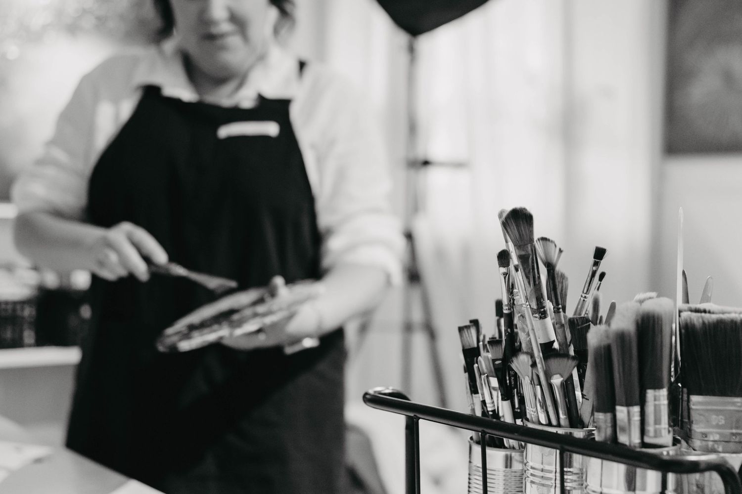 Professional bartender pouring drinks and mixing cocktails at an elegant bar counter.