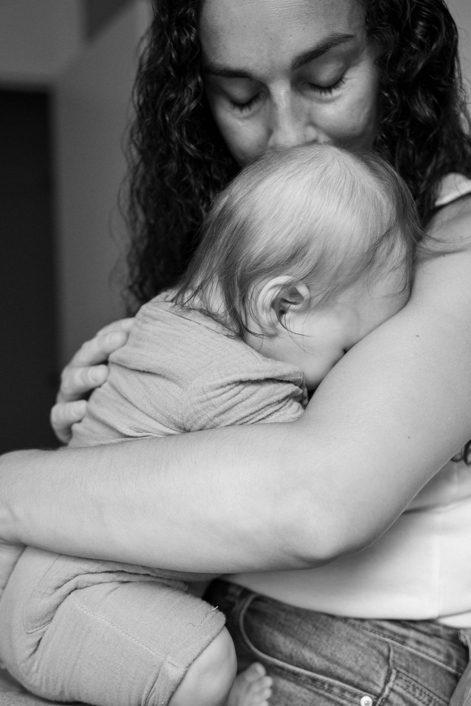 A black and white photo series showing a tender embrace between two people in an intimate emotional moment.