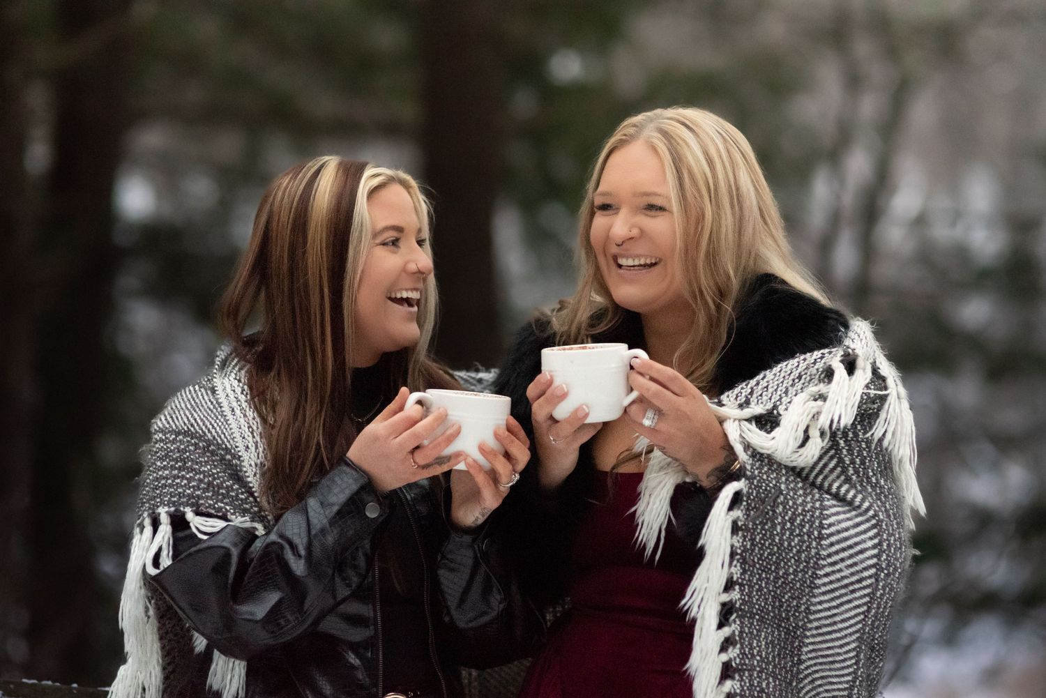 Wives laughing while drinking hot cocoa on a snowy winter day in a state park near Easton, PA