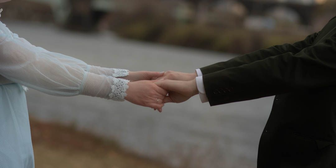 Bride and grooms hands holding each other