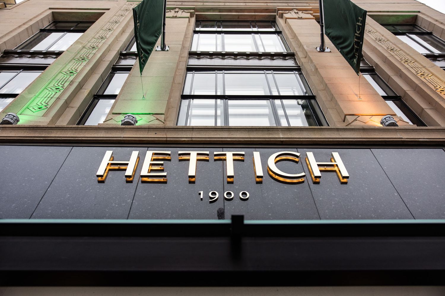 Exterior signage showing the Hettich brand name mounted on a building facade.