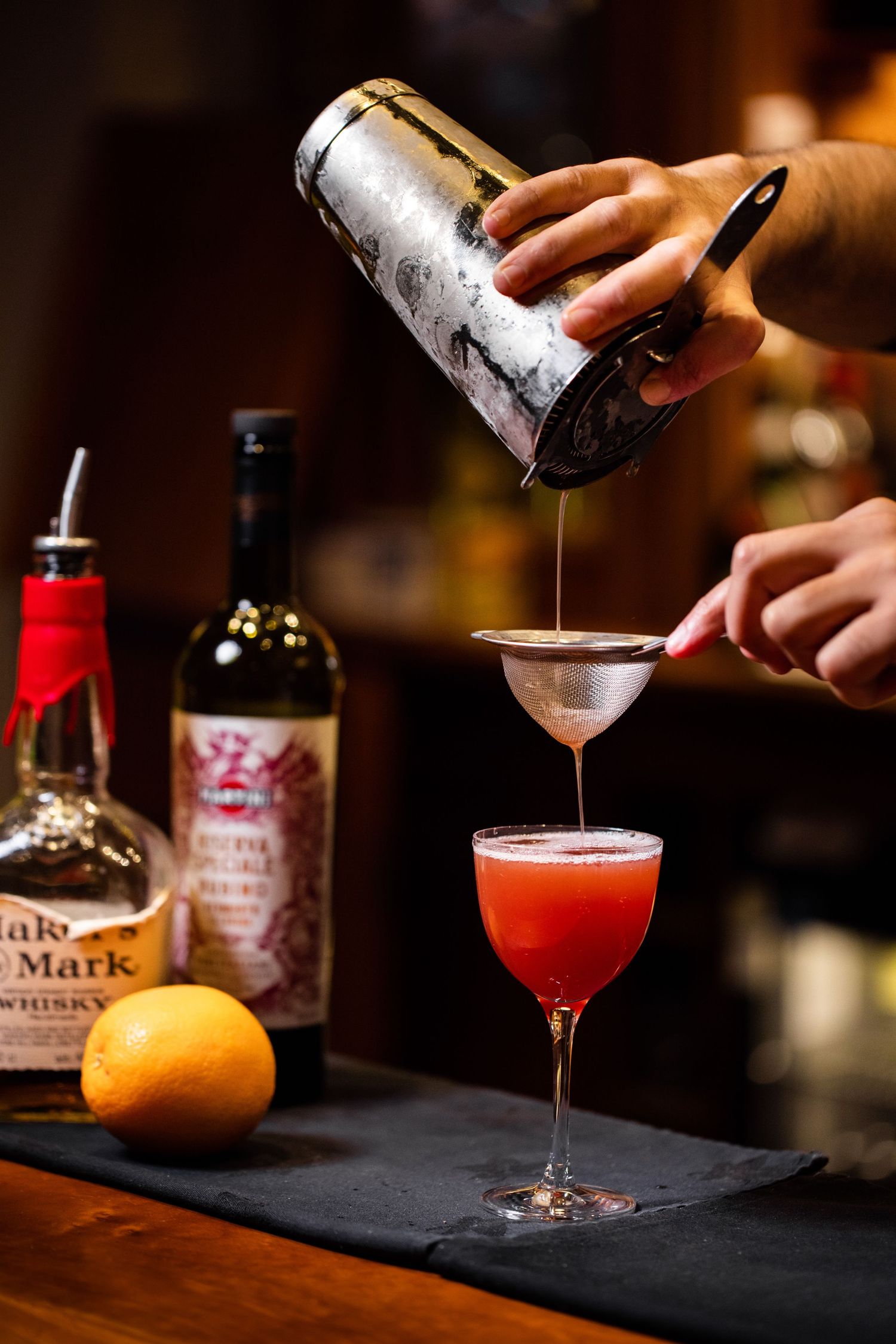 Mixologist crafting cocktails with fresh citrus and premium spirits.