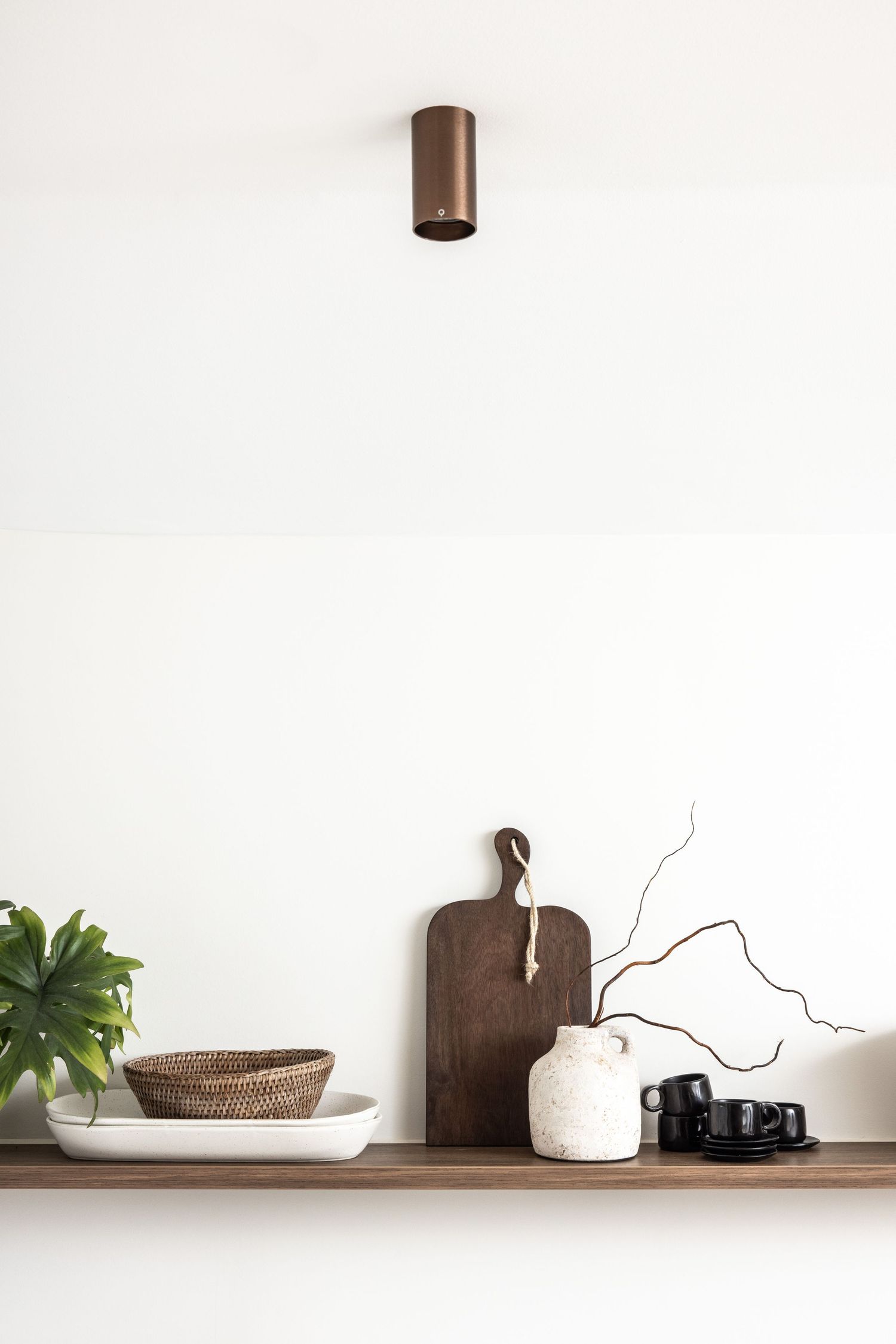 Clean white shelf styling with wooden accents and minimal decor items.