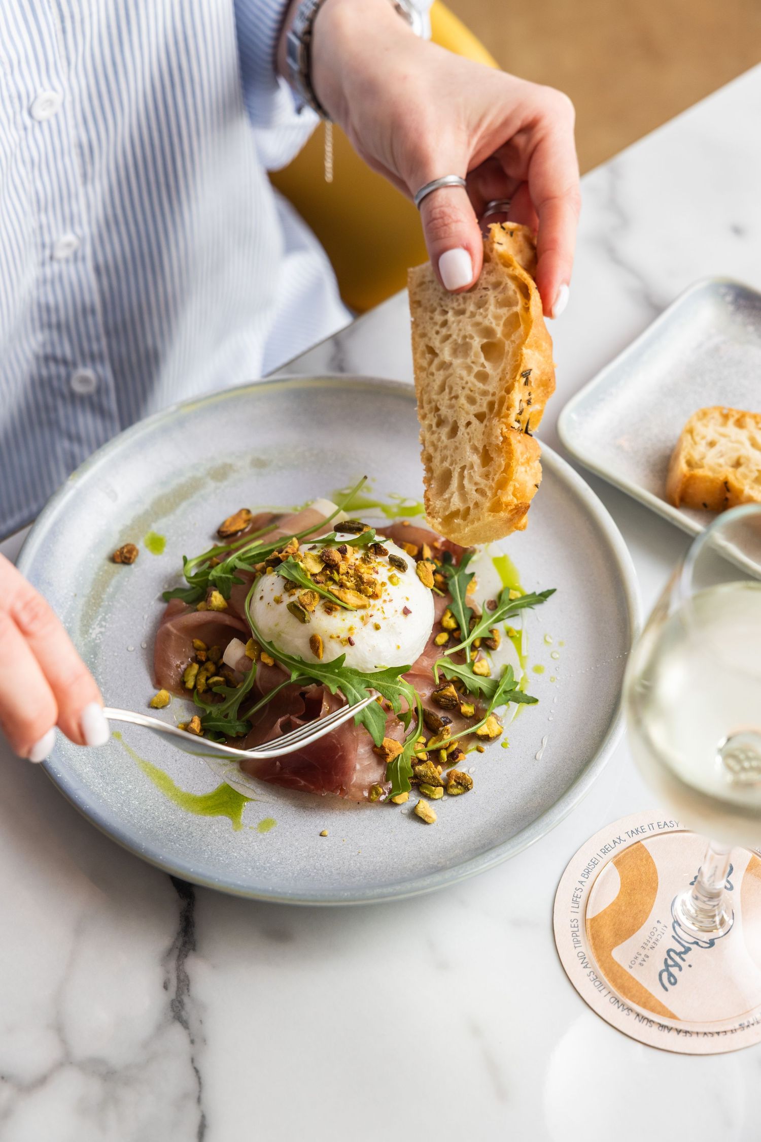 Step-by-step plating of an elegant poached egg dish with microgreens on a white ceramic plate.