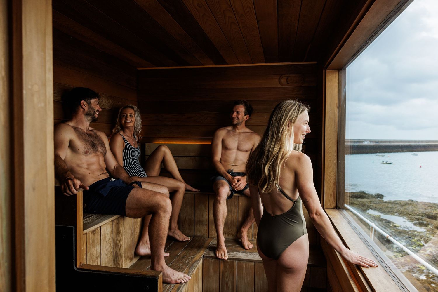 Interior view of a modern wooden sauna with ocean views.