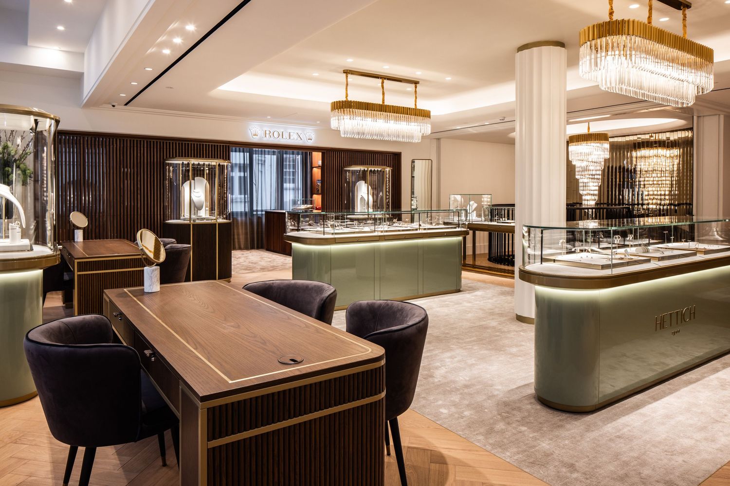High-end jewelry showroom featuring crystal lighting fixtures and elegant display counters.