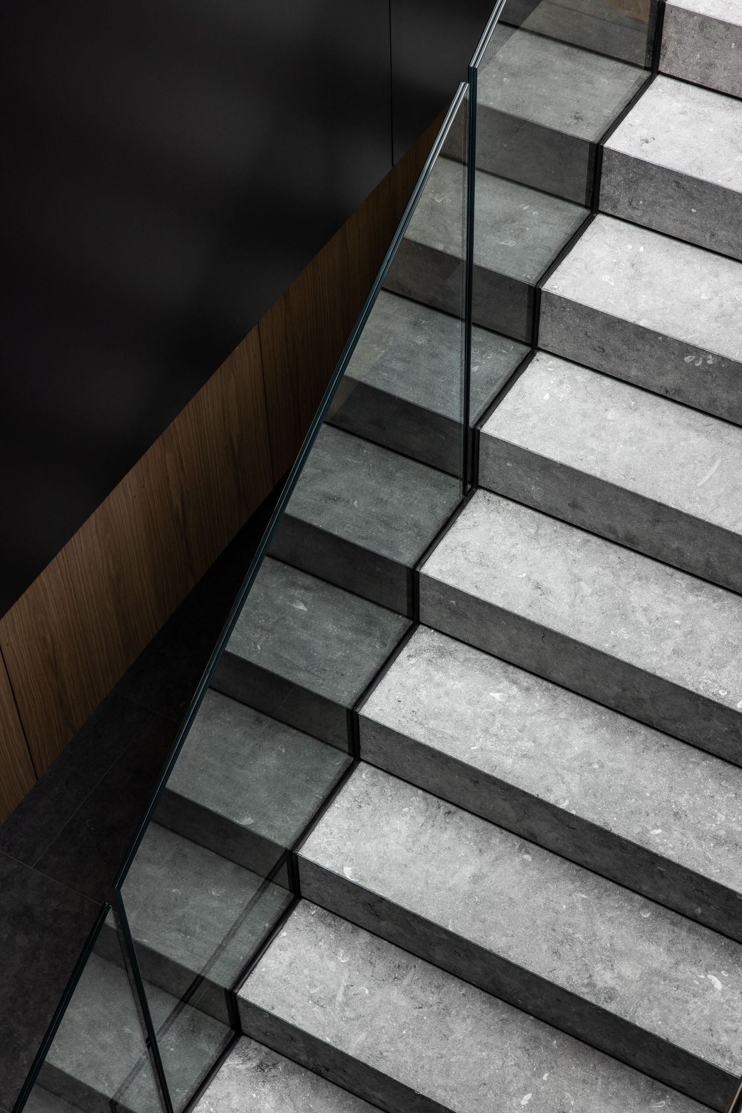 Modern concrete staircase with alternating gray and white steps creating a geometric pattern.