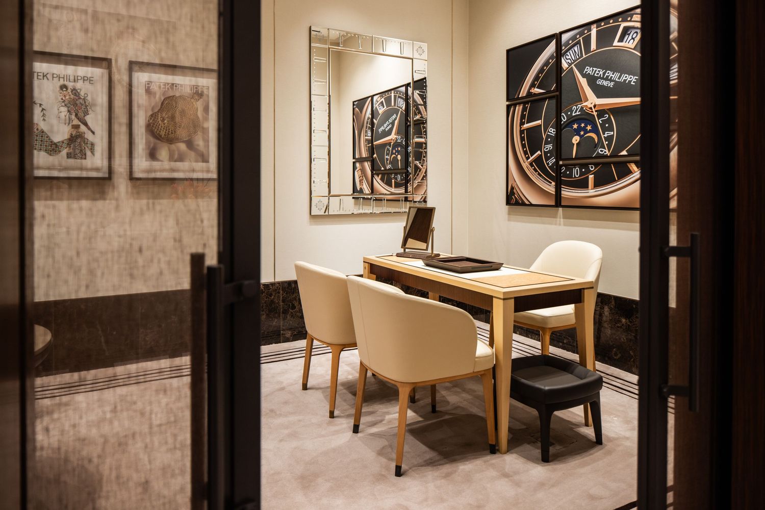 Modern consultation room with beige chairs and framed artwork on walls.