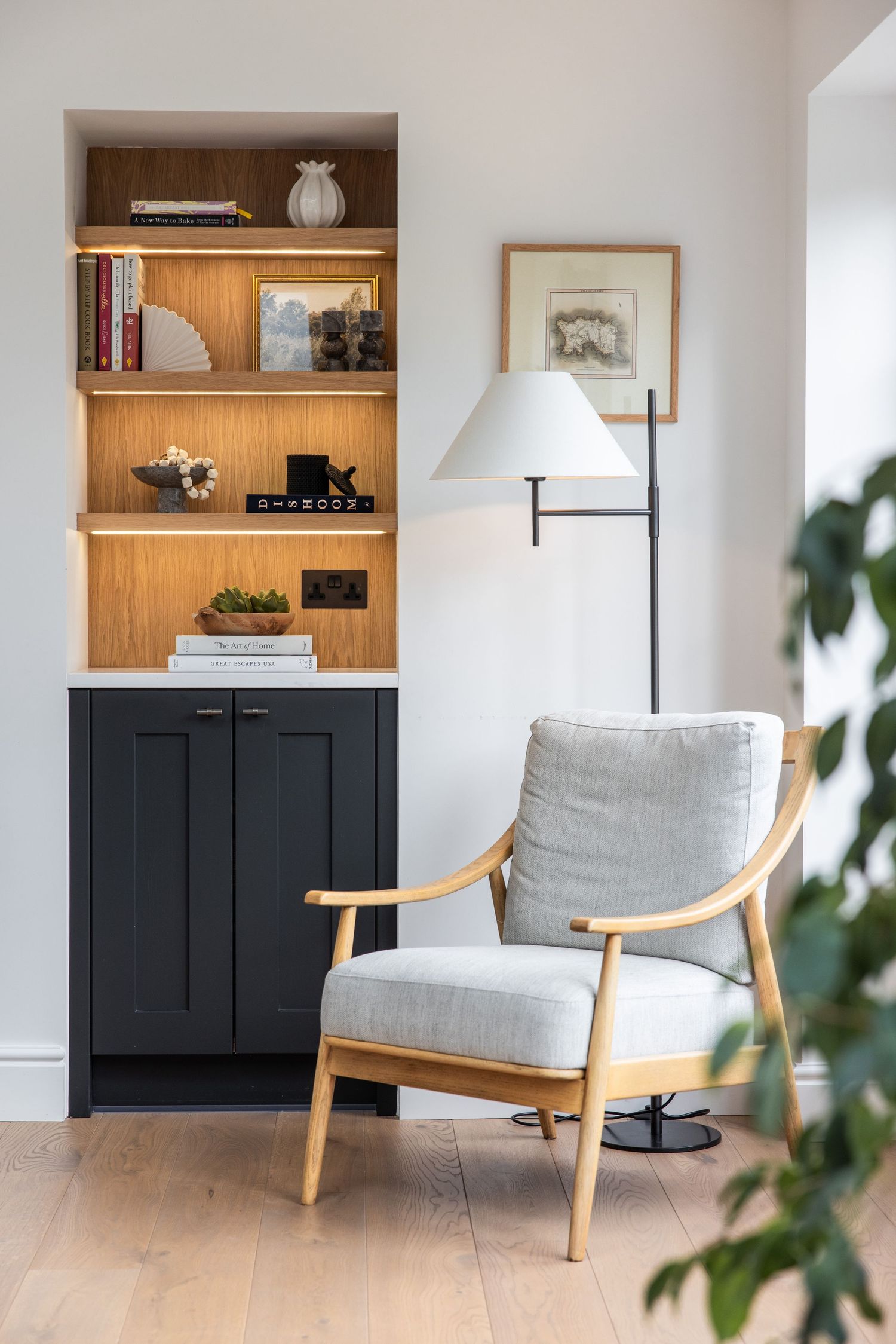 Living room with mid-century modern chairs, built-in shelving, and black cabinet storage.