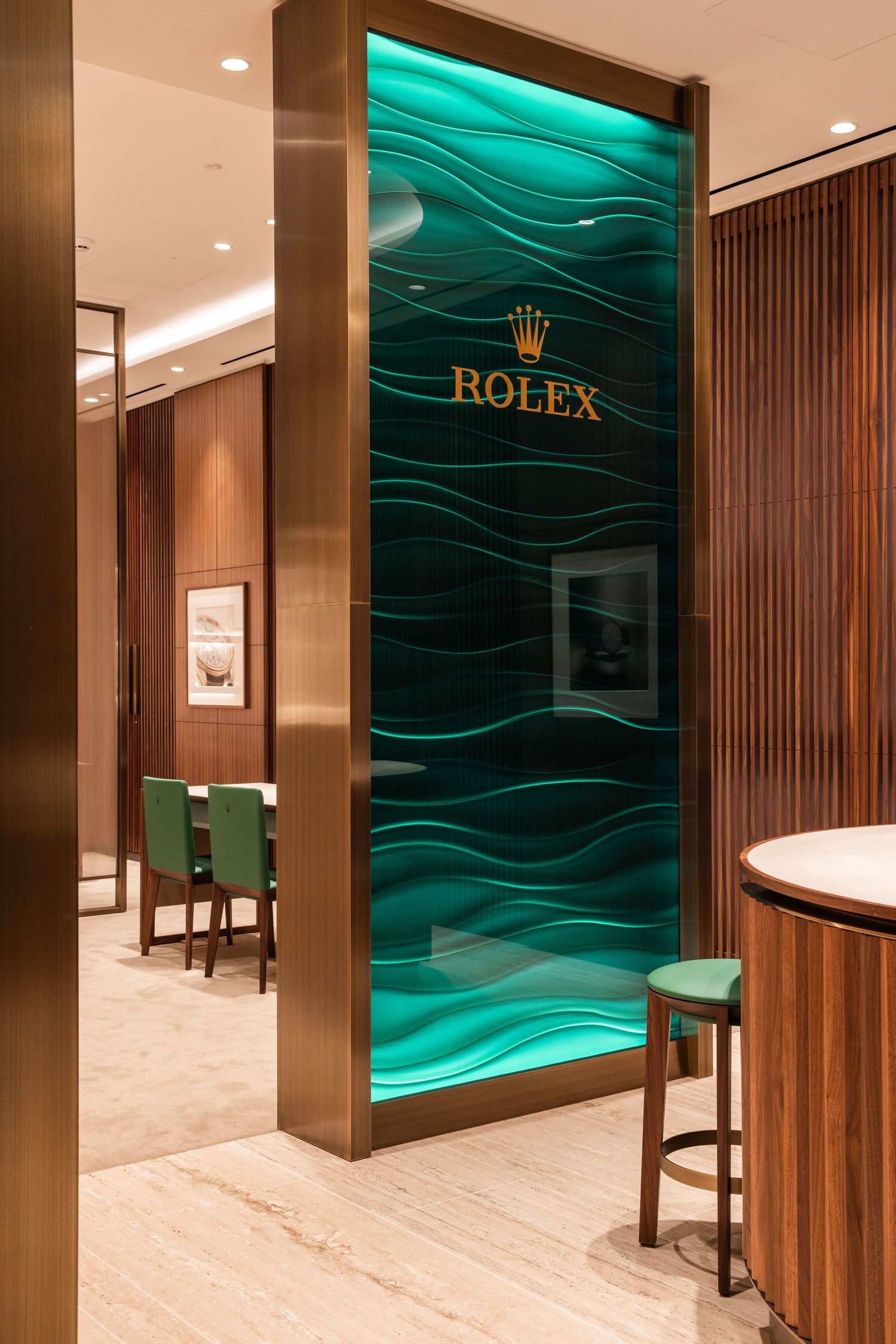Rolex boutique interior with emerald green wave wall panels and dark wood accents.