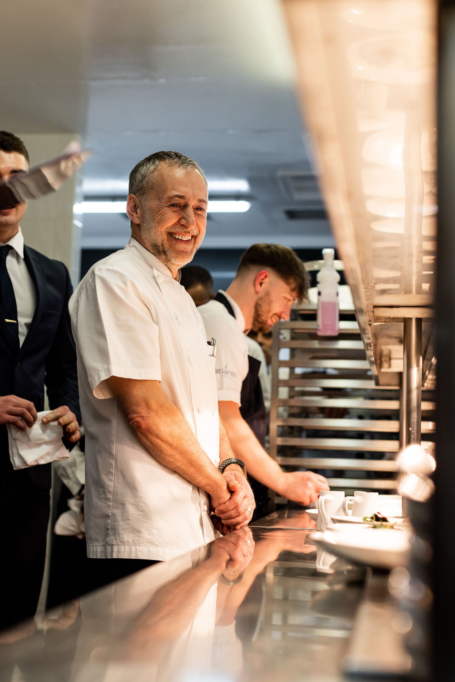 Chefs working together in a busy professional kitchen during service.