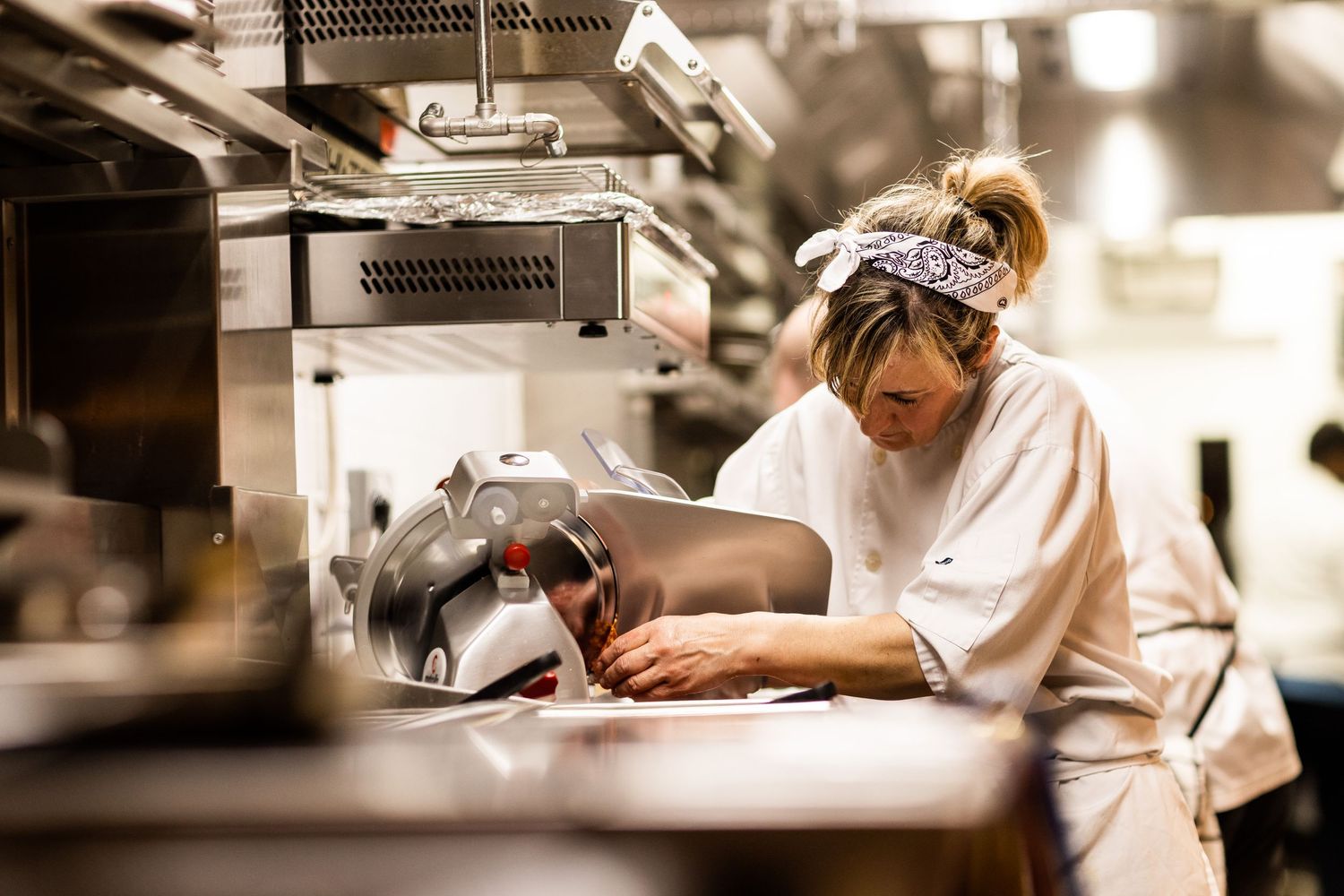 Restaurant kitchen staff focused on preparing dishes during service.