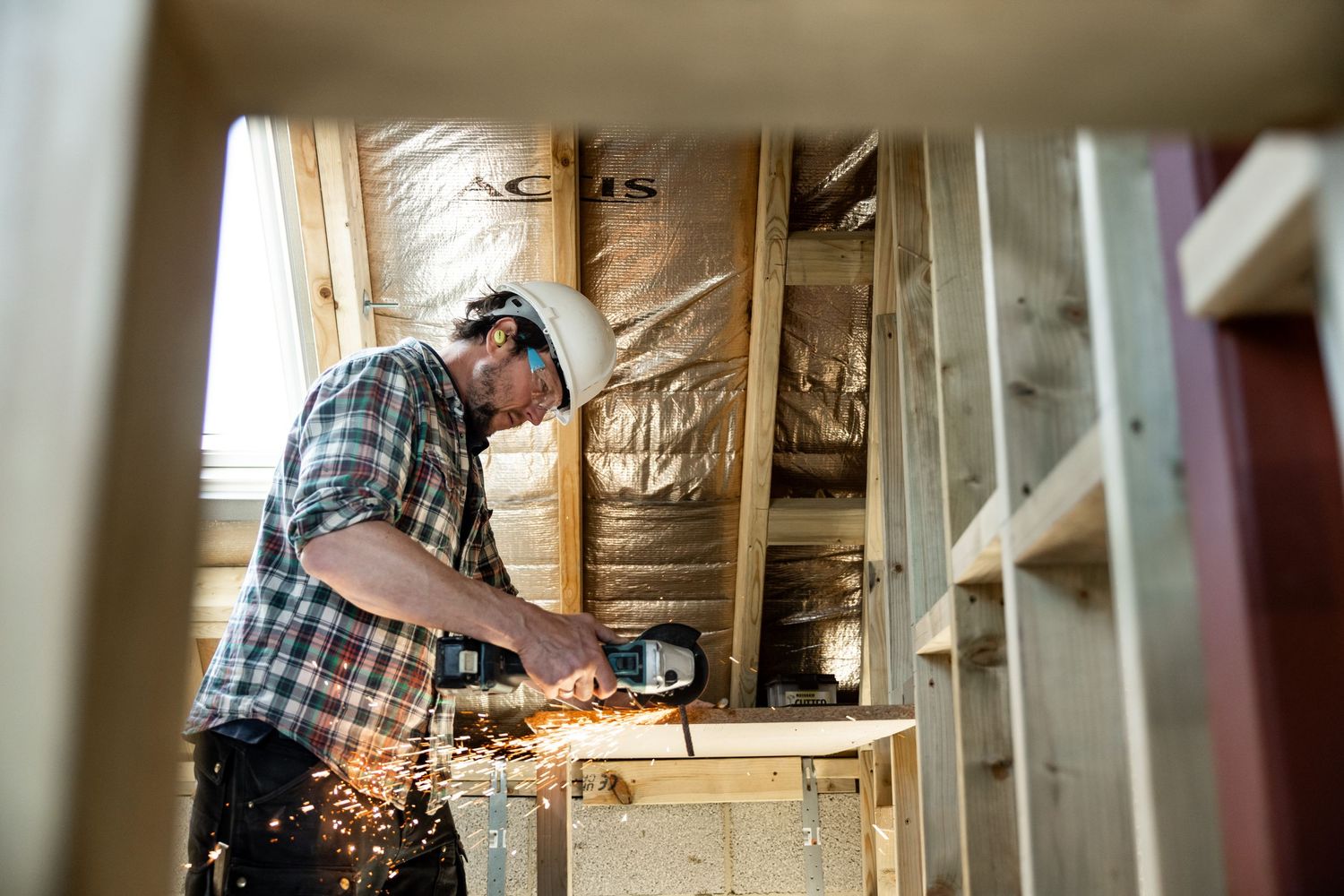 Sparks flying during indoor construction work with power tools.