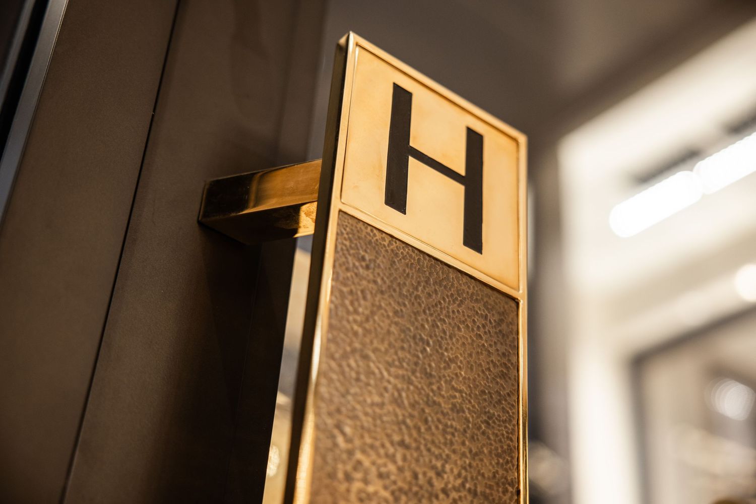 Modern gold and black textured wall panels with dramatic shadows and lighting effects.