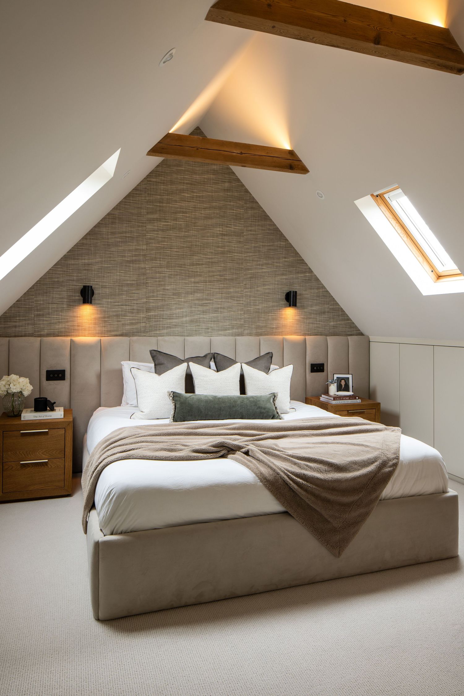 Attic bedroom with sloped ceiling, exposed beams, and modern minimalist design.