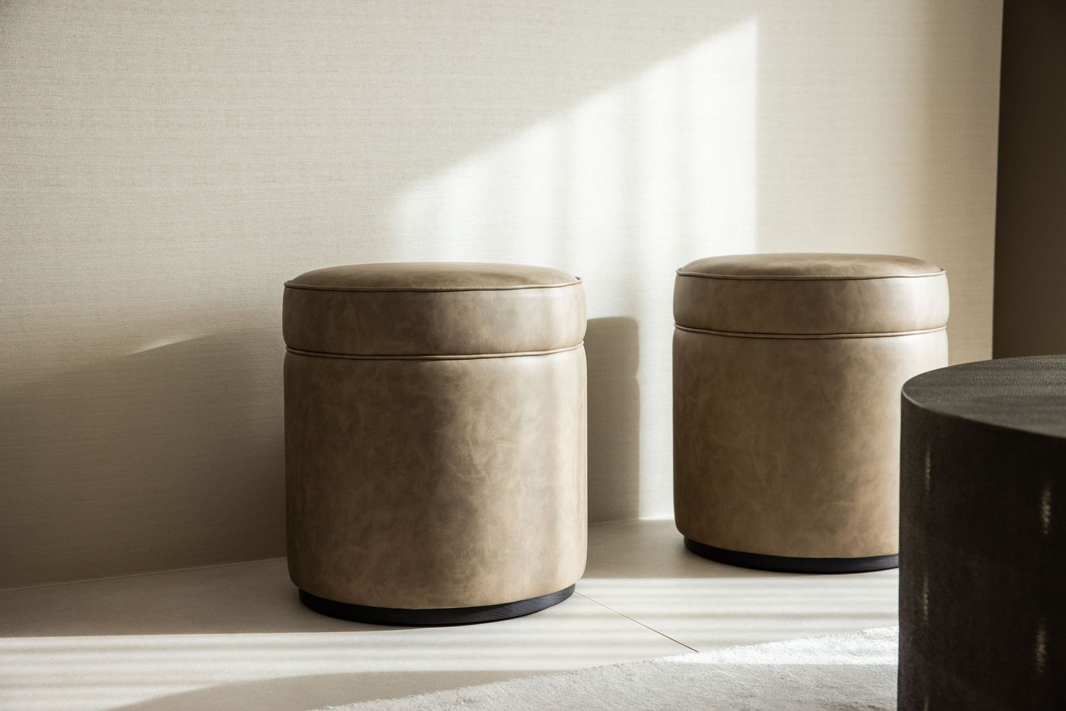 Neutral-toned ceramic vessels arranged in natural lighting creating an artistic display.