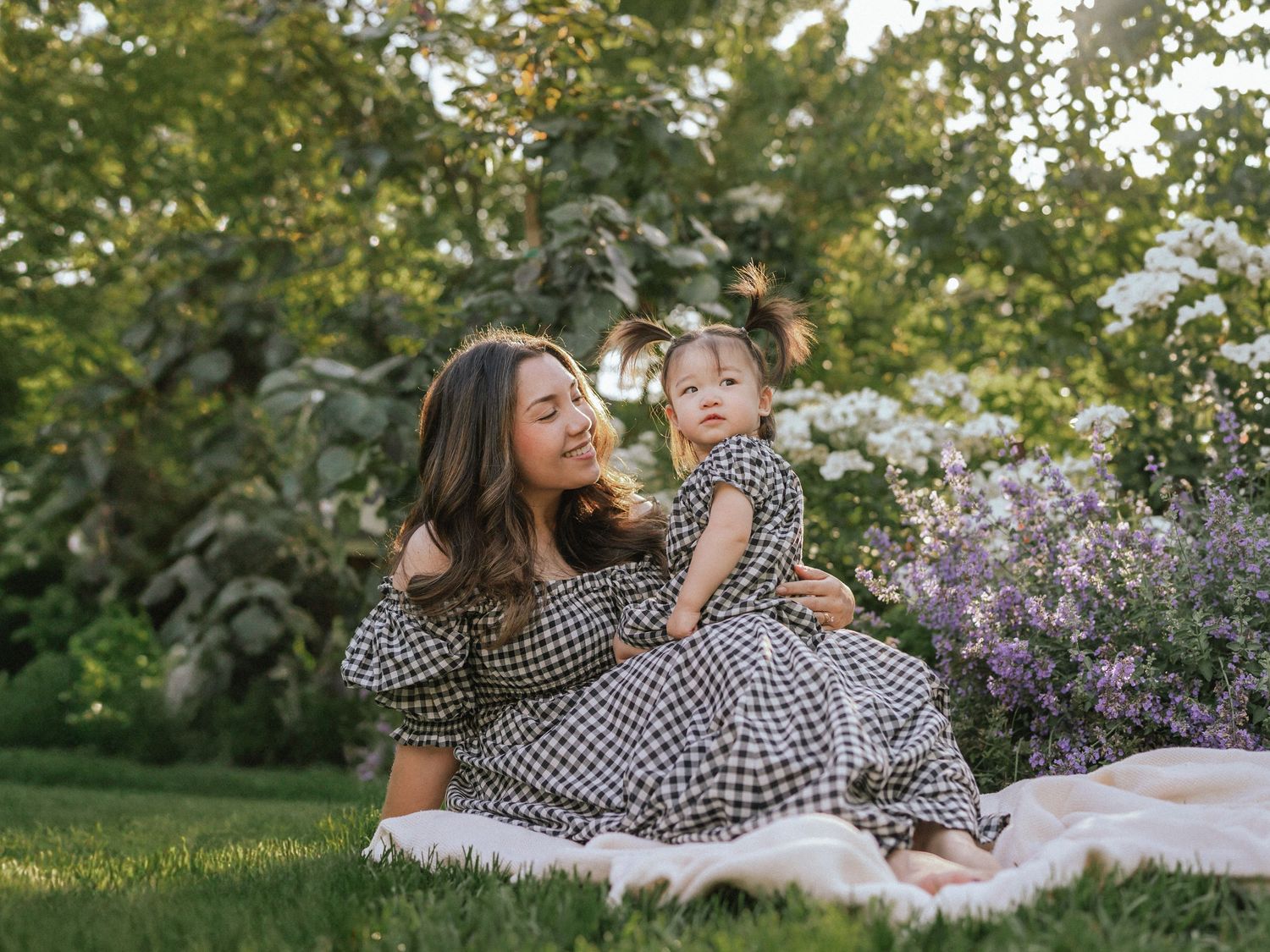 A relaxing outdoor photoshoot in a garden with blooming flowers and greenery.