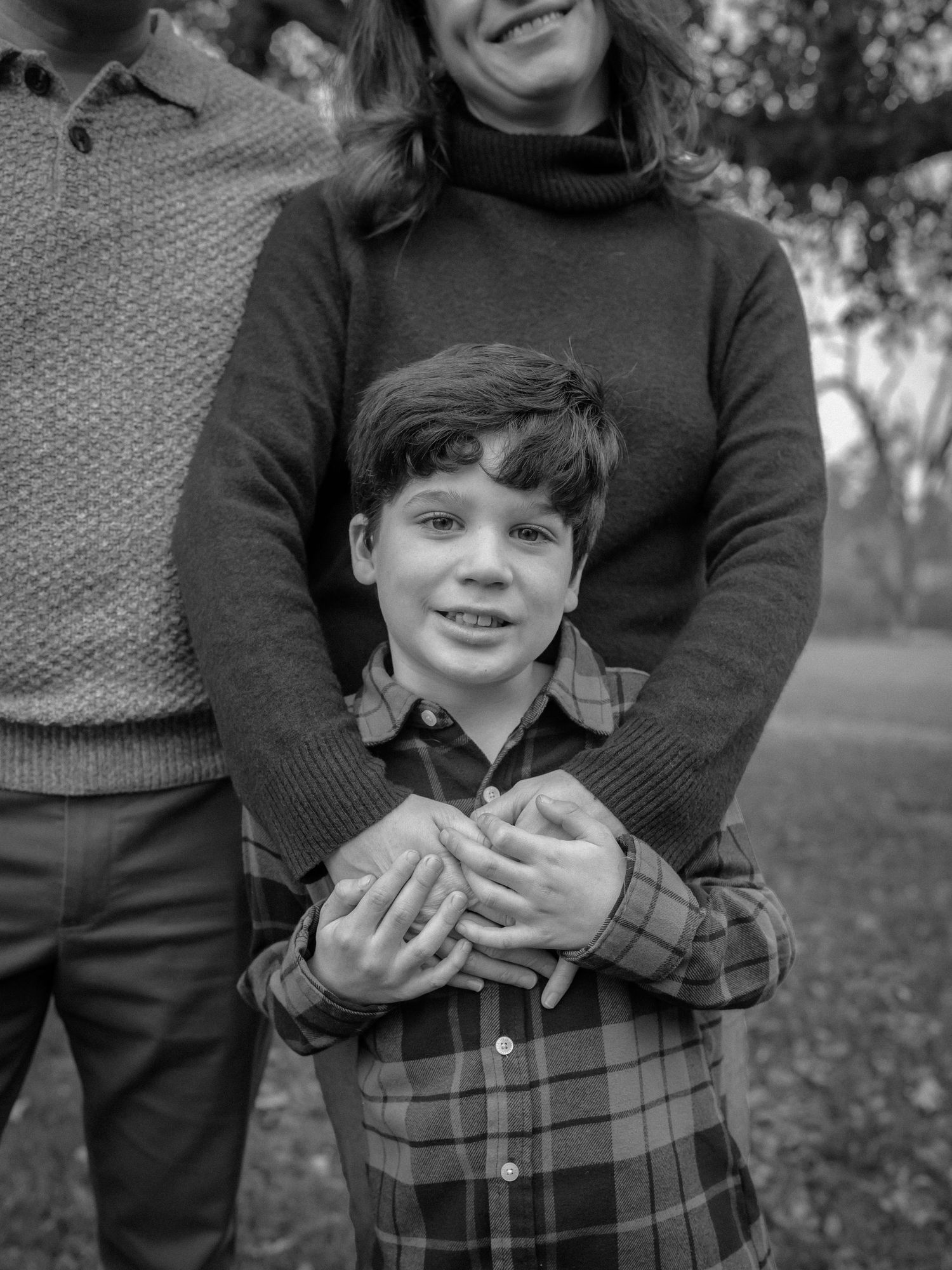 Black and white portrait series showing warm embraces outdoors.