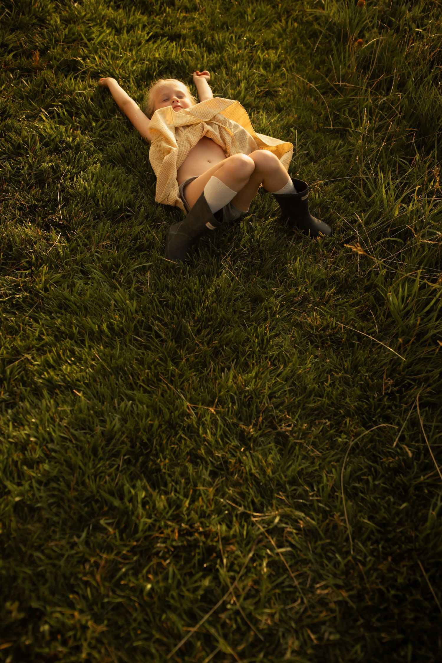A baby doll lies abandoned on green grass in a sequence of similar shots showing different angles and positions.