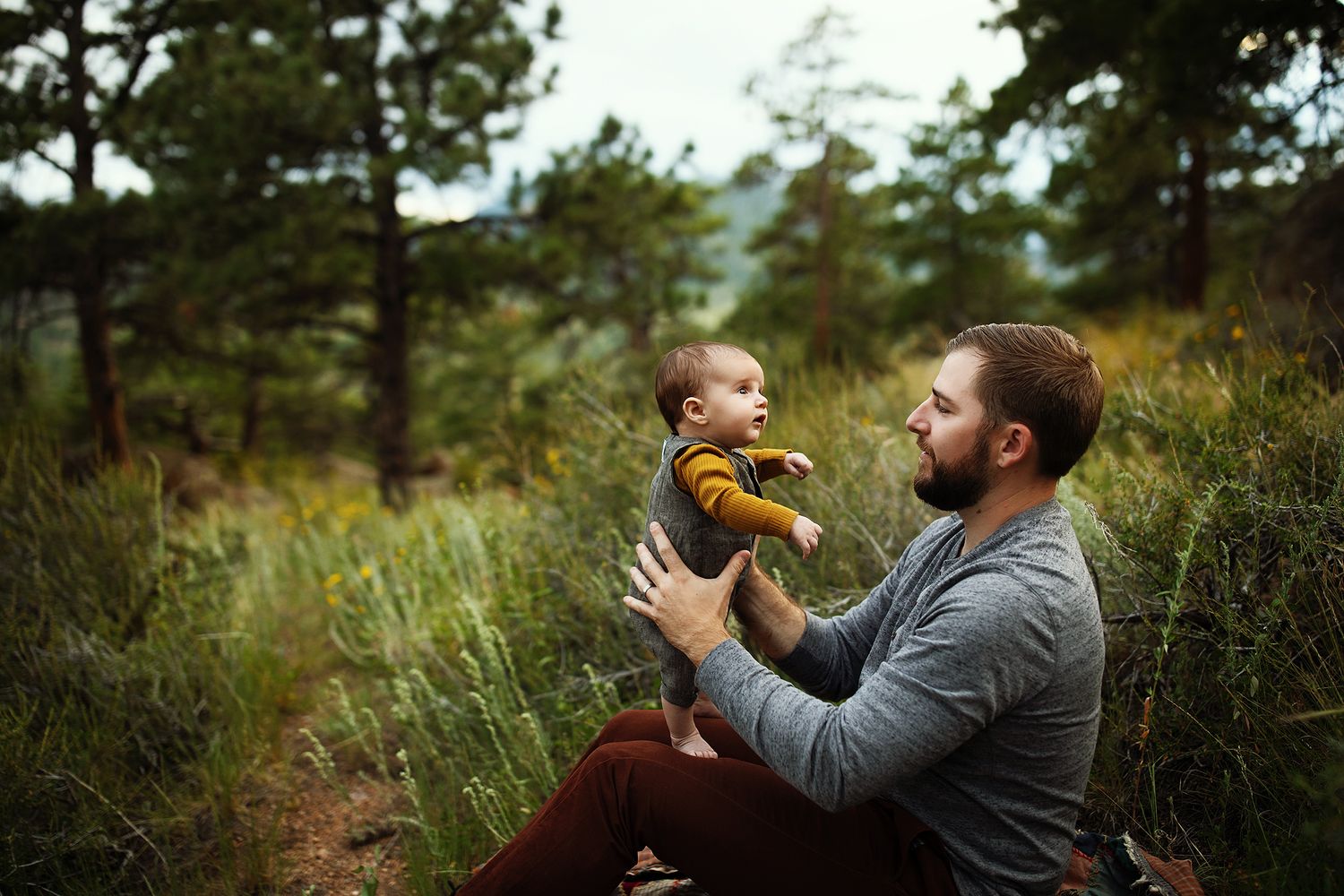 Joyful outdoor family moment captured in forest setting.