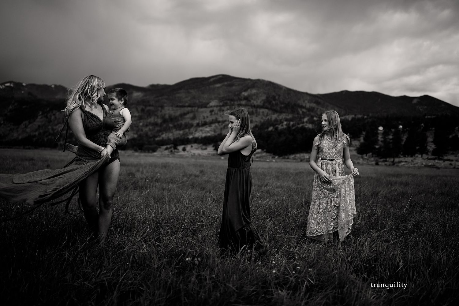 Dramatic black and white landscape photography with people in field.