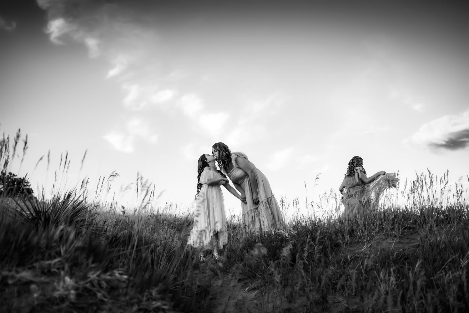 Black and white landscape portraits of couple in mountain field.