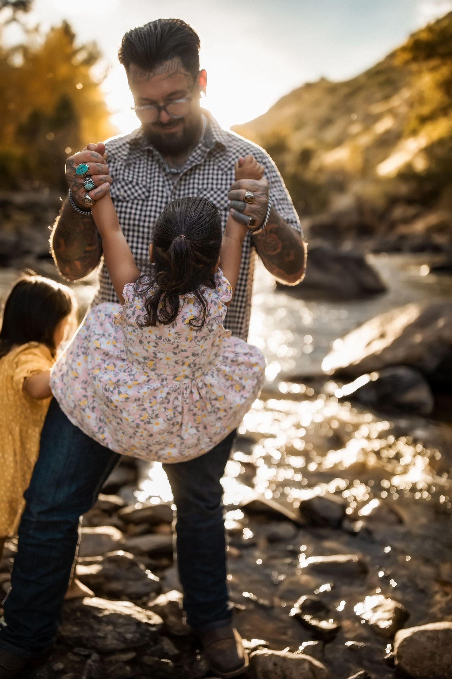 Sequence showing joyful interaction between two people near a sunlit rocky shoreline.